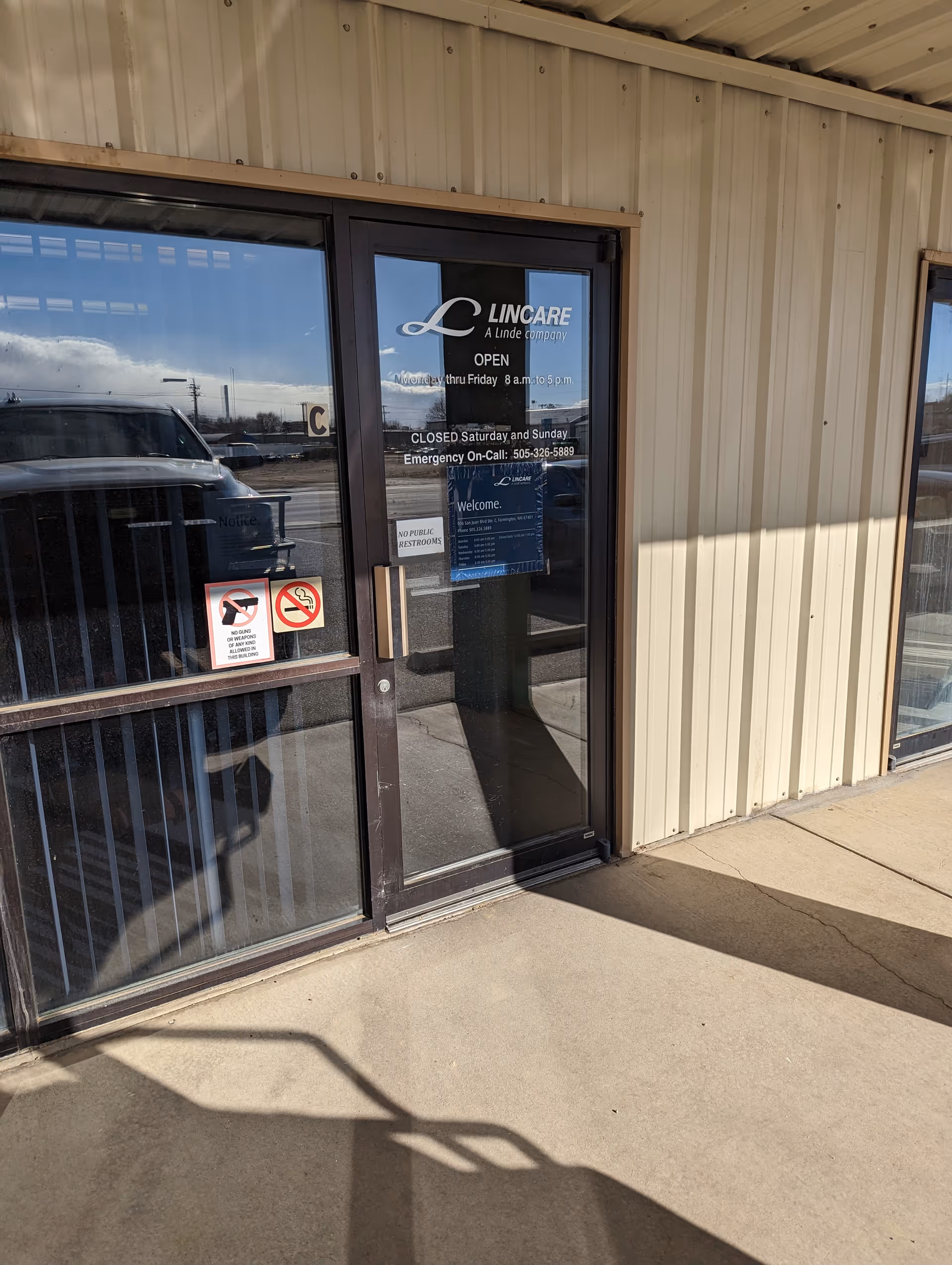 Exterior view of an entrance door with Lincare signage on a metal-framed building.