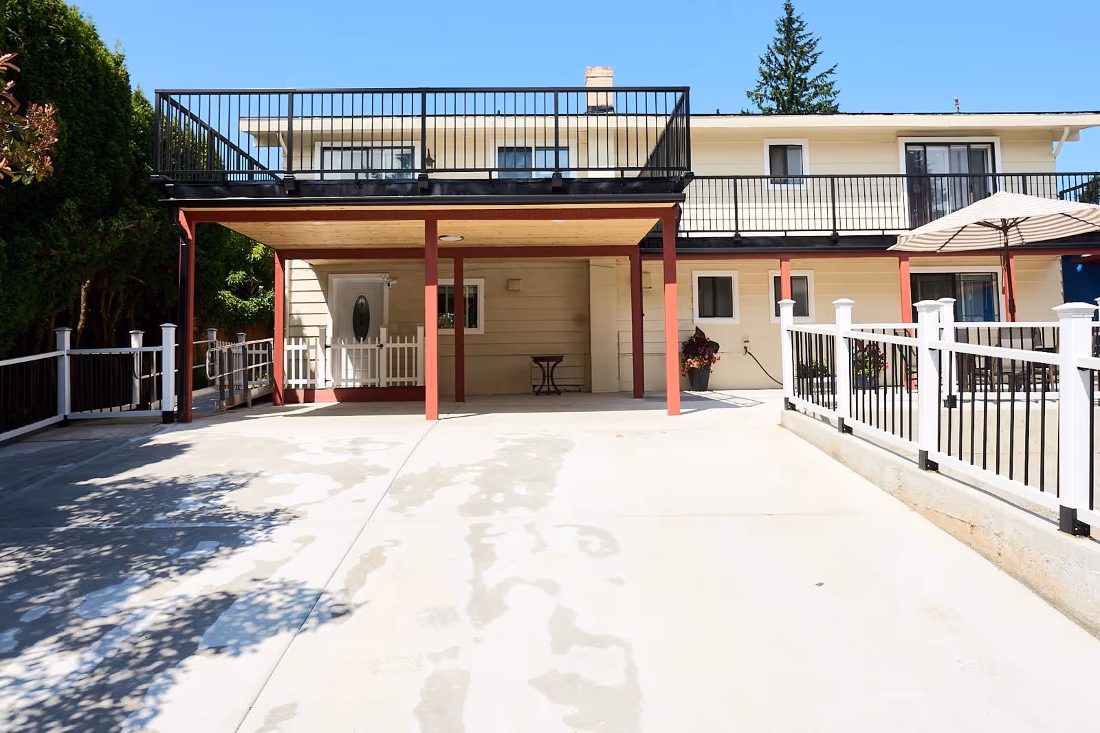 Exterior view of Apex Care Adult Family Home with a covered patio and outdoor seating.