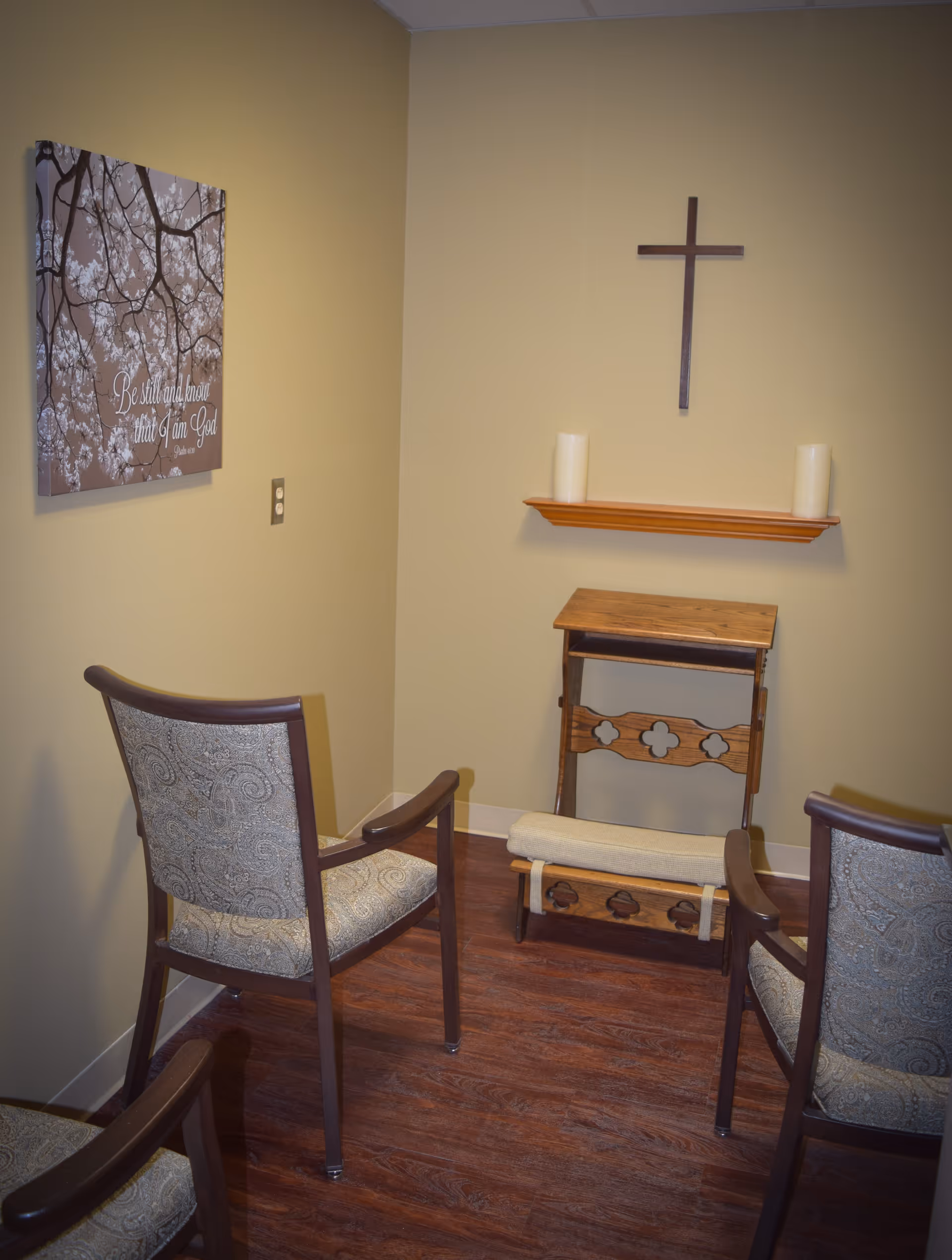Small chapel area with altar, cross, candles, and seating.