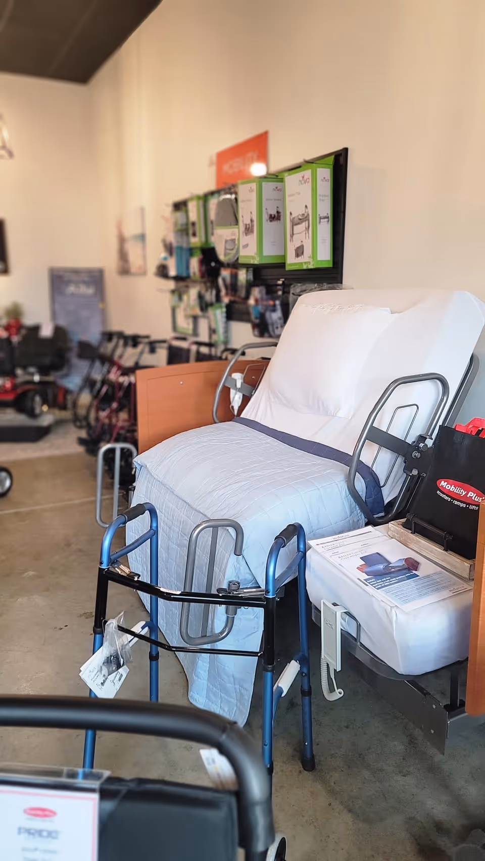 Hospital bed and mobility aids on display in a Mobility Plus showroom