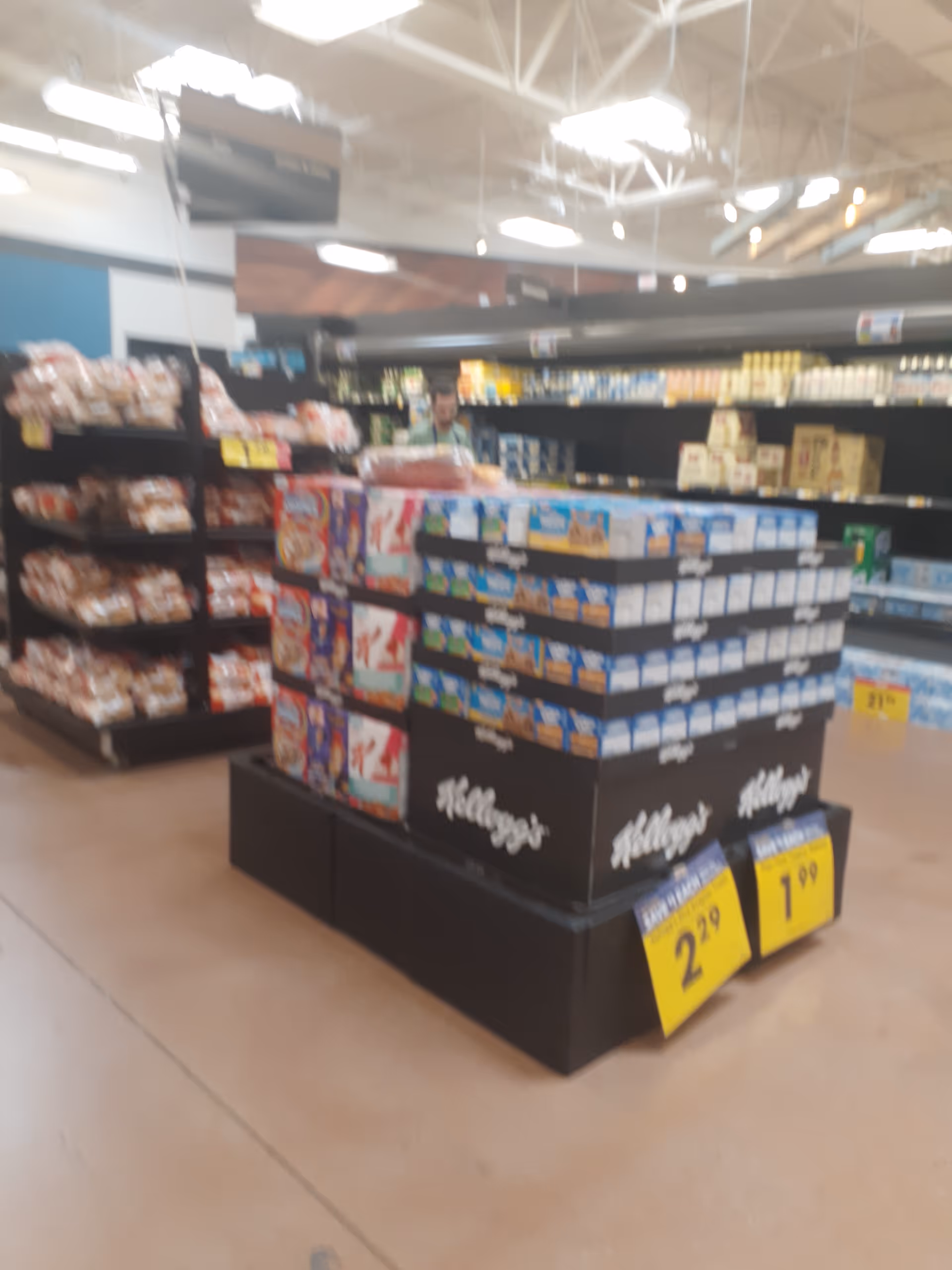 Interior of a grocery store showcasing a Kellogg's cereal display.