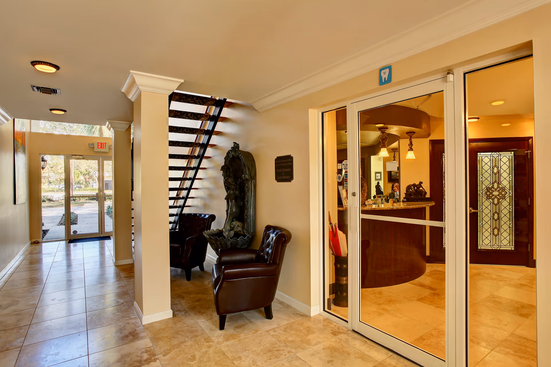 Interior lobby with stairs, leather chairs, and glass reception area in a My Visiting Nurse facility.
