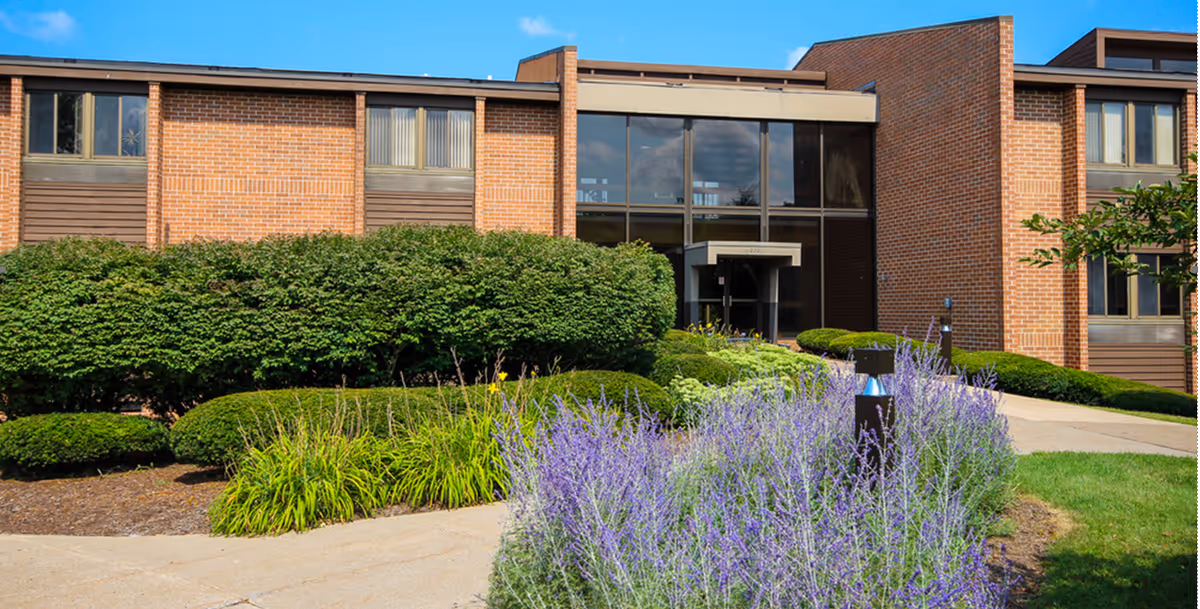 Exterior view of Comfort Keepers Home Care building with landscaped entrance and lavender garden