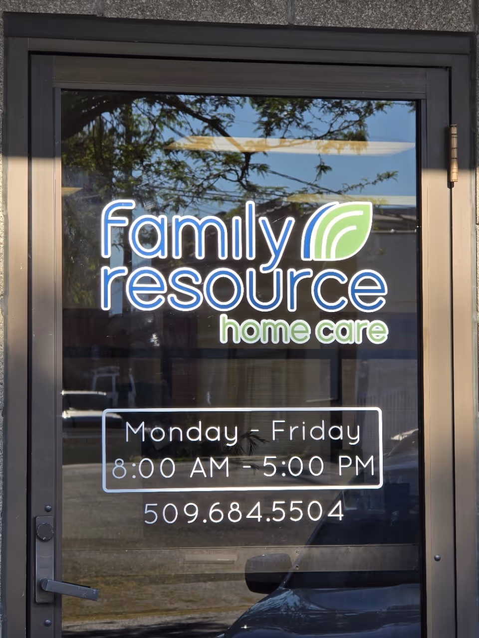 Glass door displays Family Resource Home Care logo, hours, and phone number.