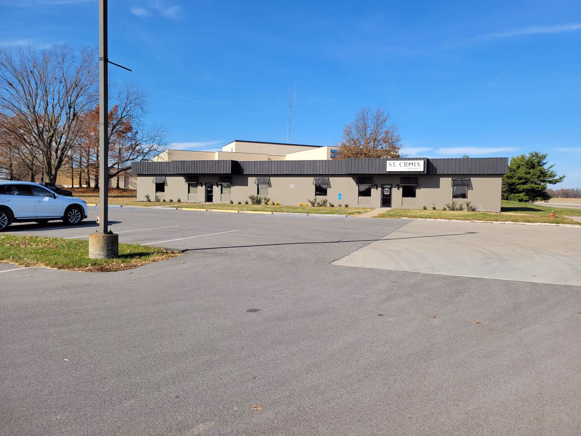 Single-story medical facility with a parking lot and a sign reading St. Croix Hospice