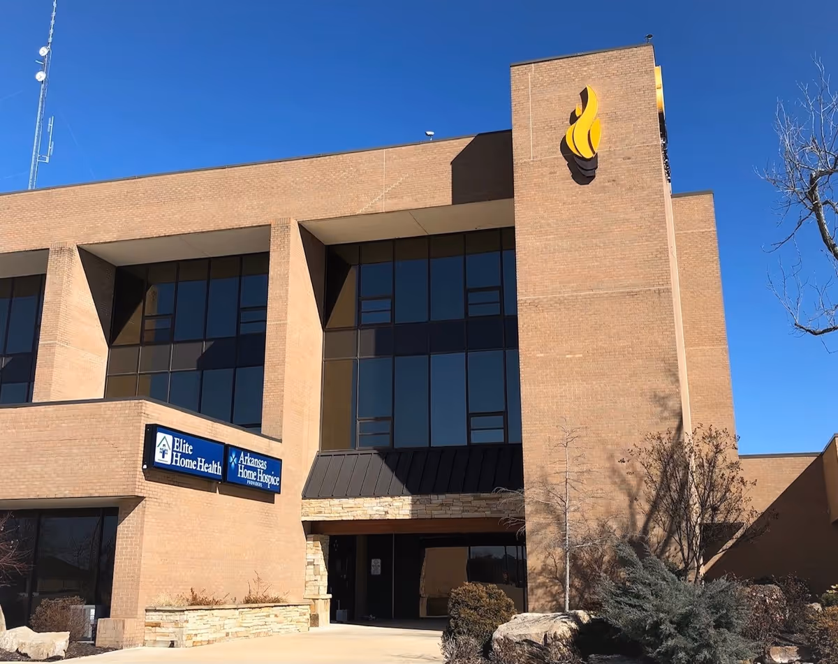 Exterior view of a brick medical building with large windows and Elite Home Health sign.
