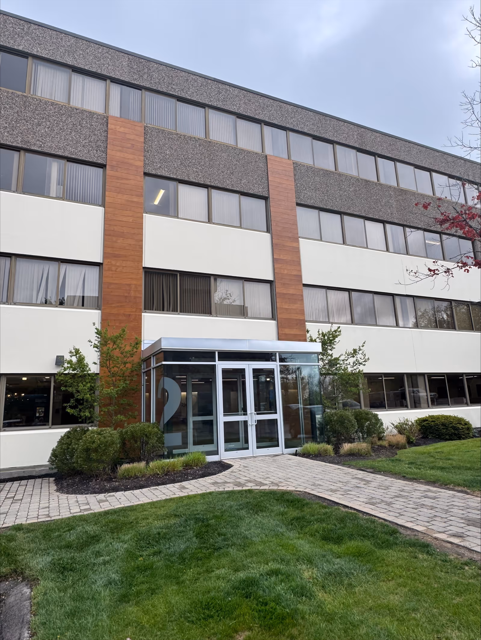 Exterior view of BAYADA Home Health building with glass entrance and landscaped front