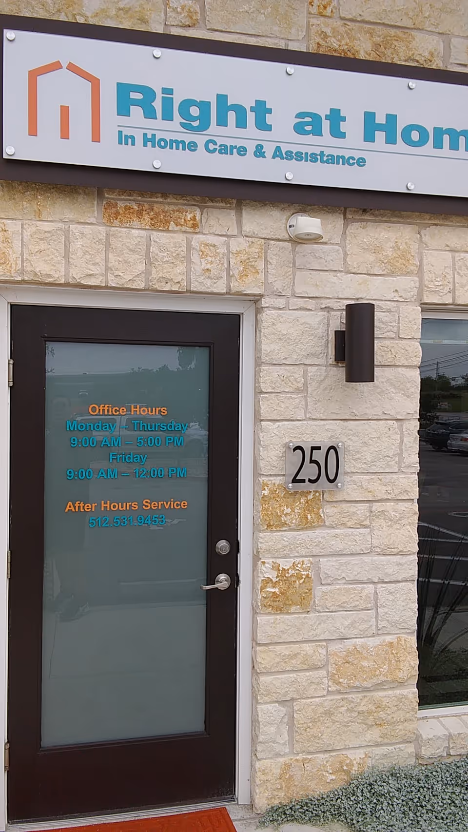 Exterior view of Right at Home entrance with sign and address 250