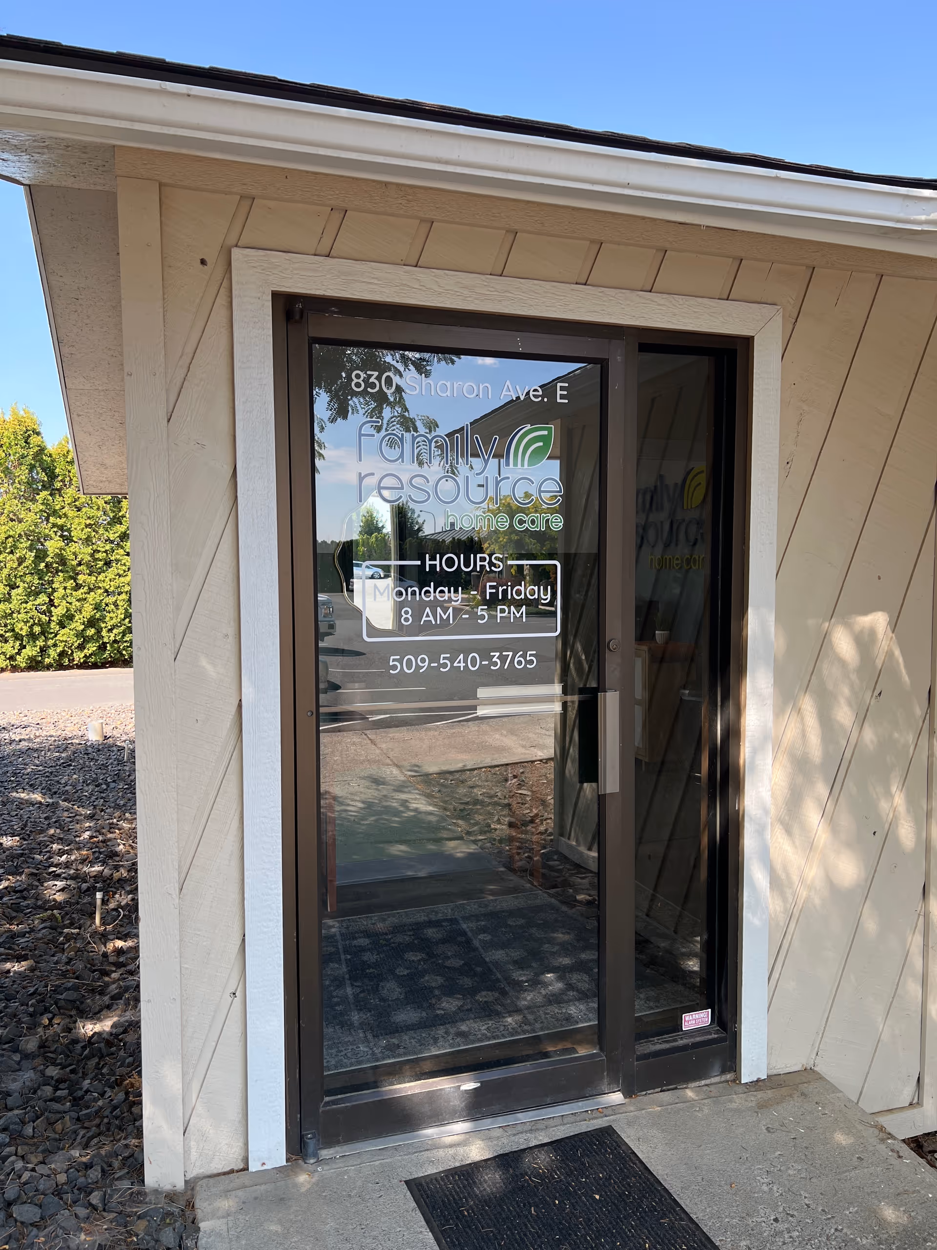Front entrance of Family Resource Home Care building with glass door.