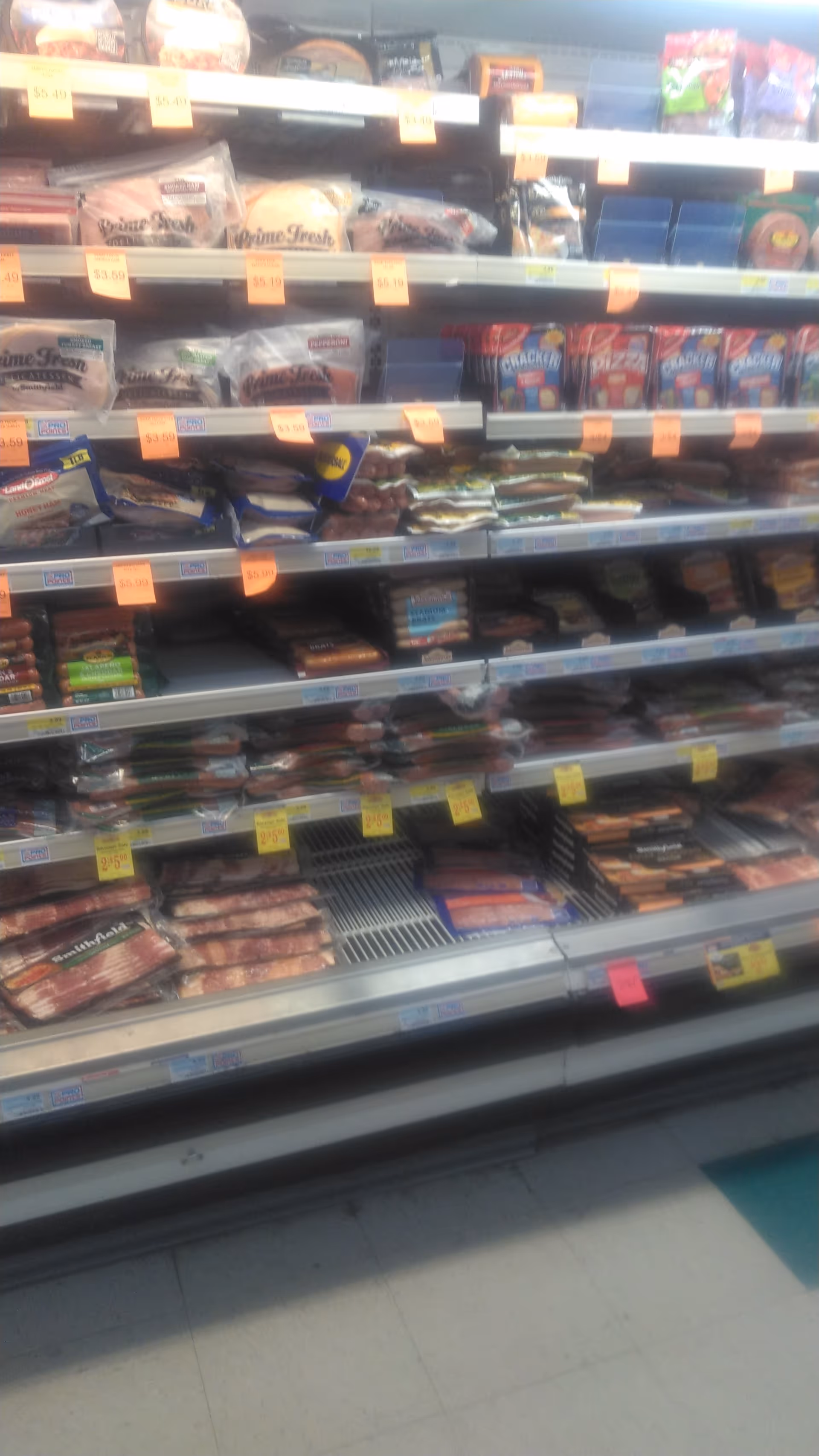 Indoor Discount Drug Mart aisle with shelves of packaged snacks and foods.