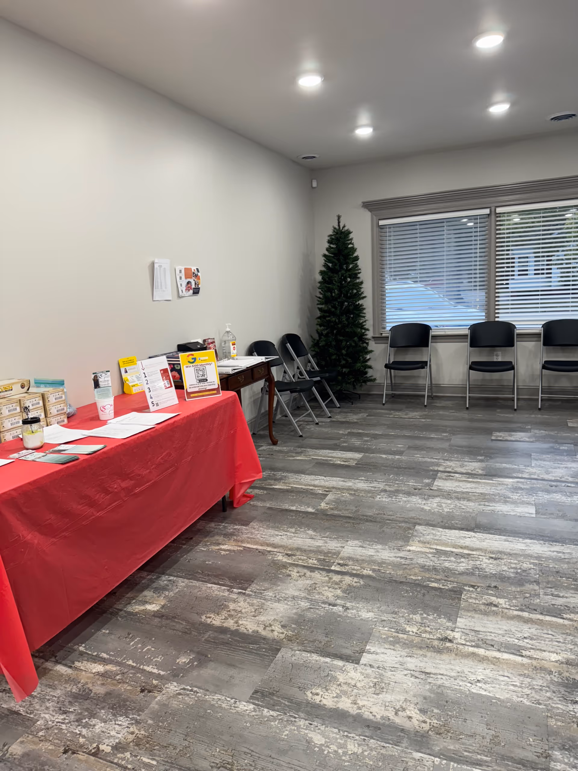 Registration table with brochures in a quiet indoor waiting area.