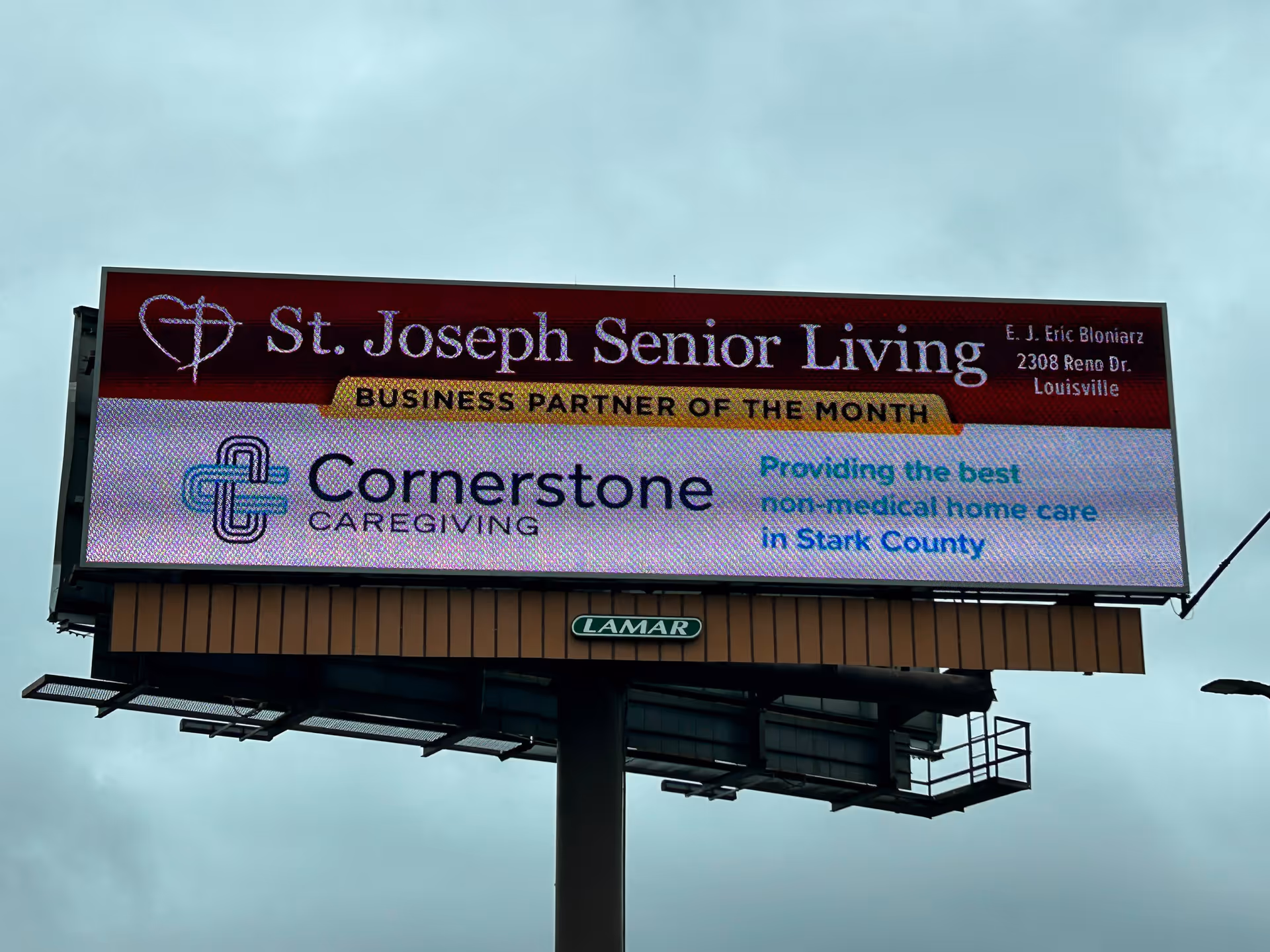 Outdoor billboard atop a pole advertising St. Joseph Senior Living and Cornerstone Caregiving.