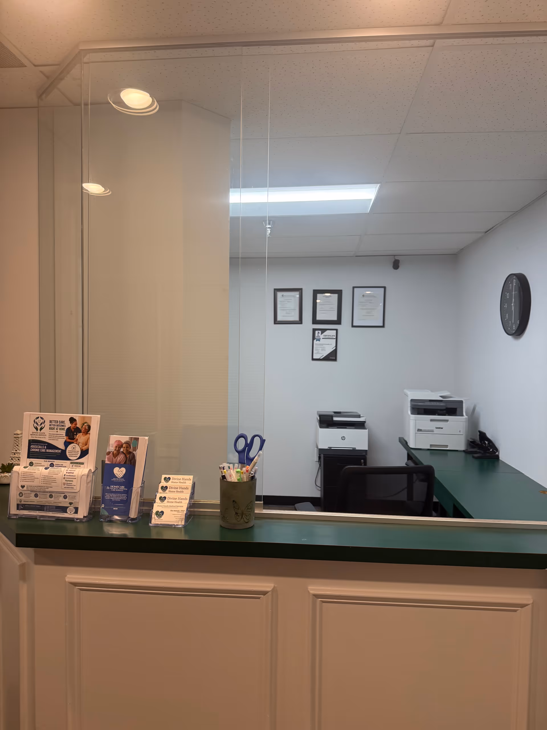 Reception desk with brochures and a window into an office in a senior care facility.