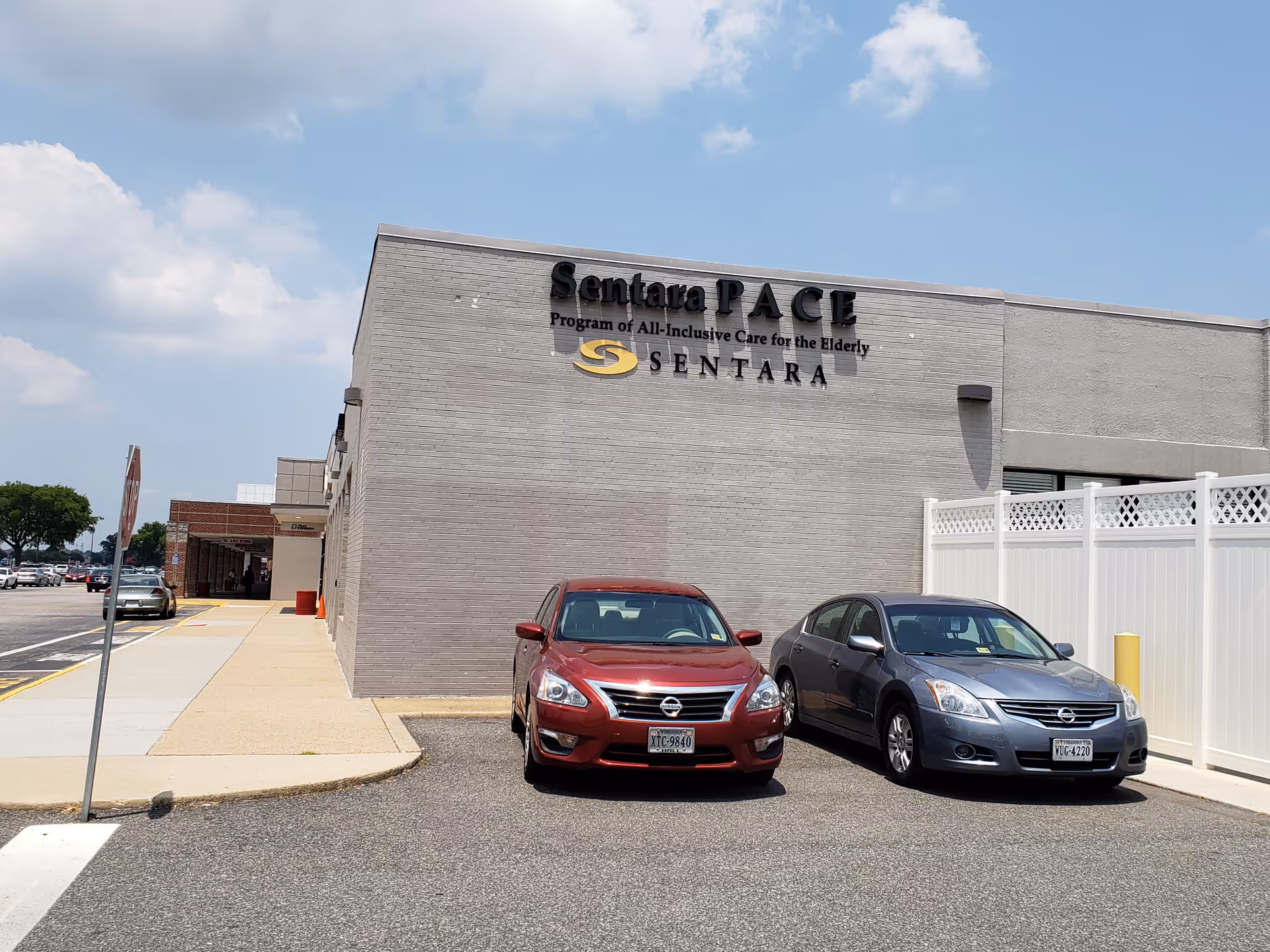Sentara PACE building exterior with parked cars and blue sky.