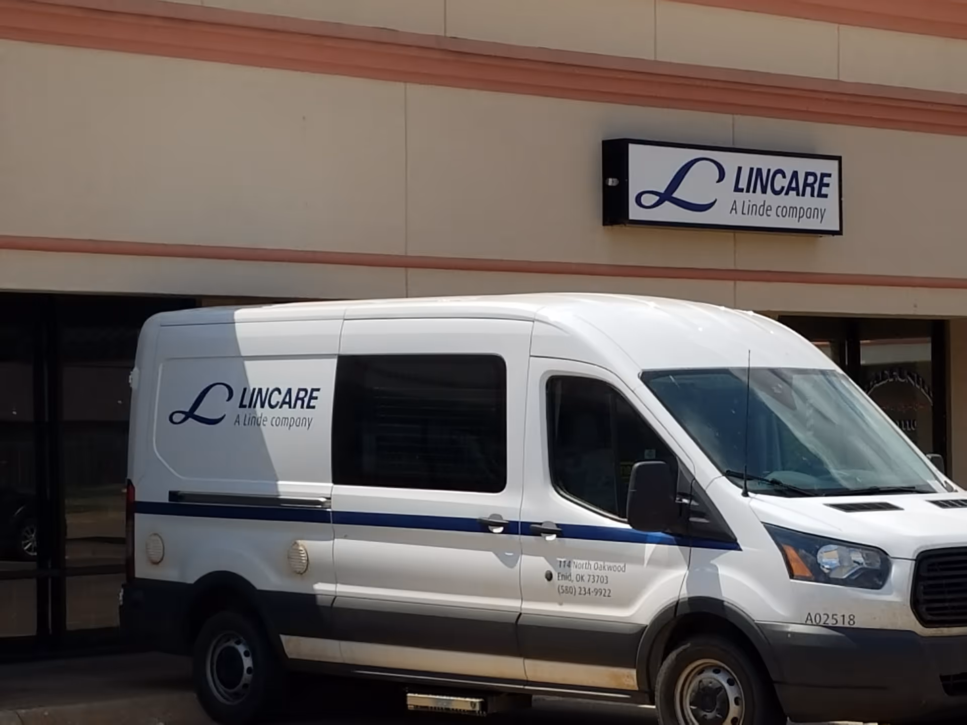 White Lincare van parked in front of a building with Lincare signage.