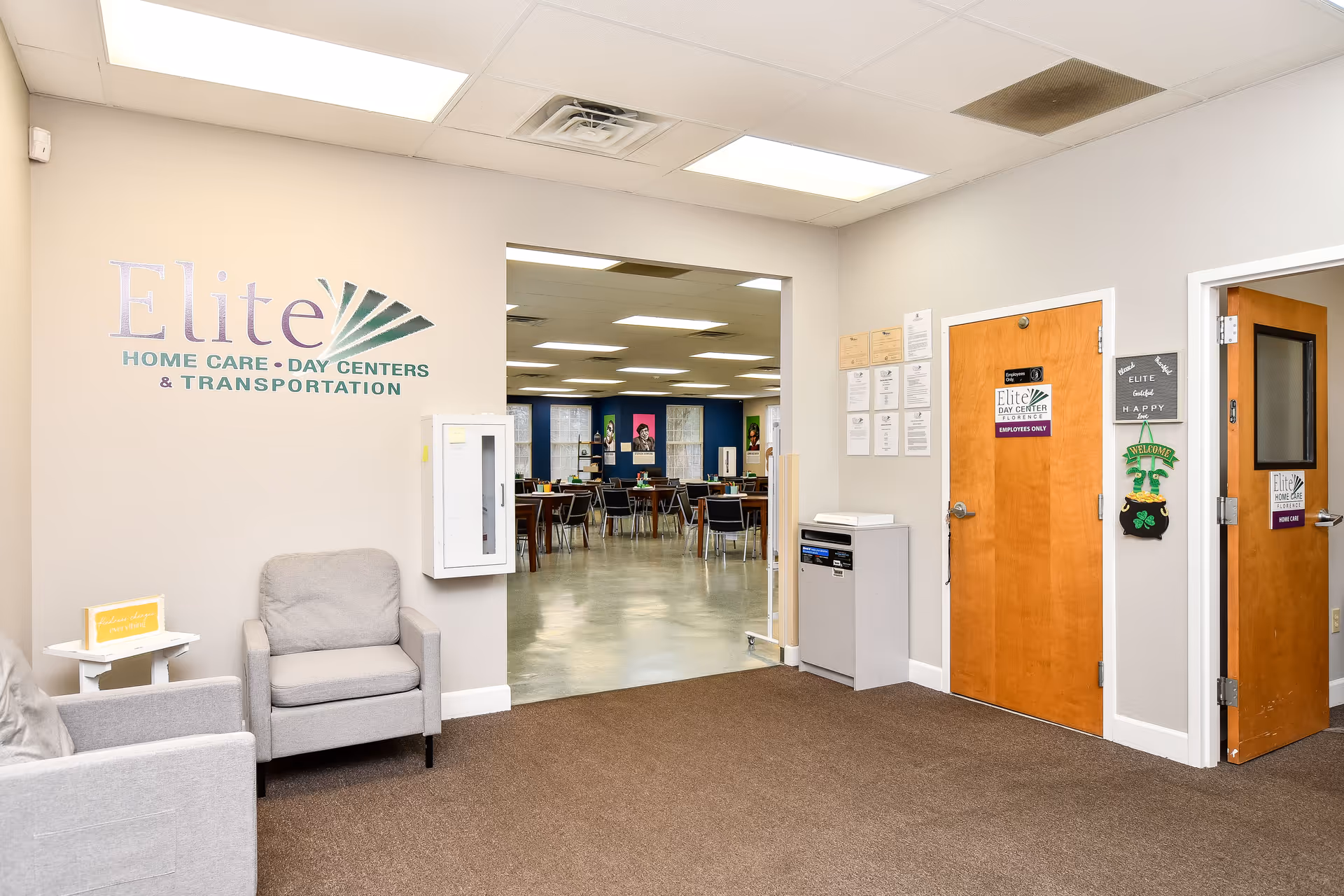 Lobby area of Elite Home Care and Day Centers with chairs and a dining area visible.