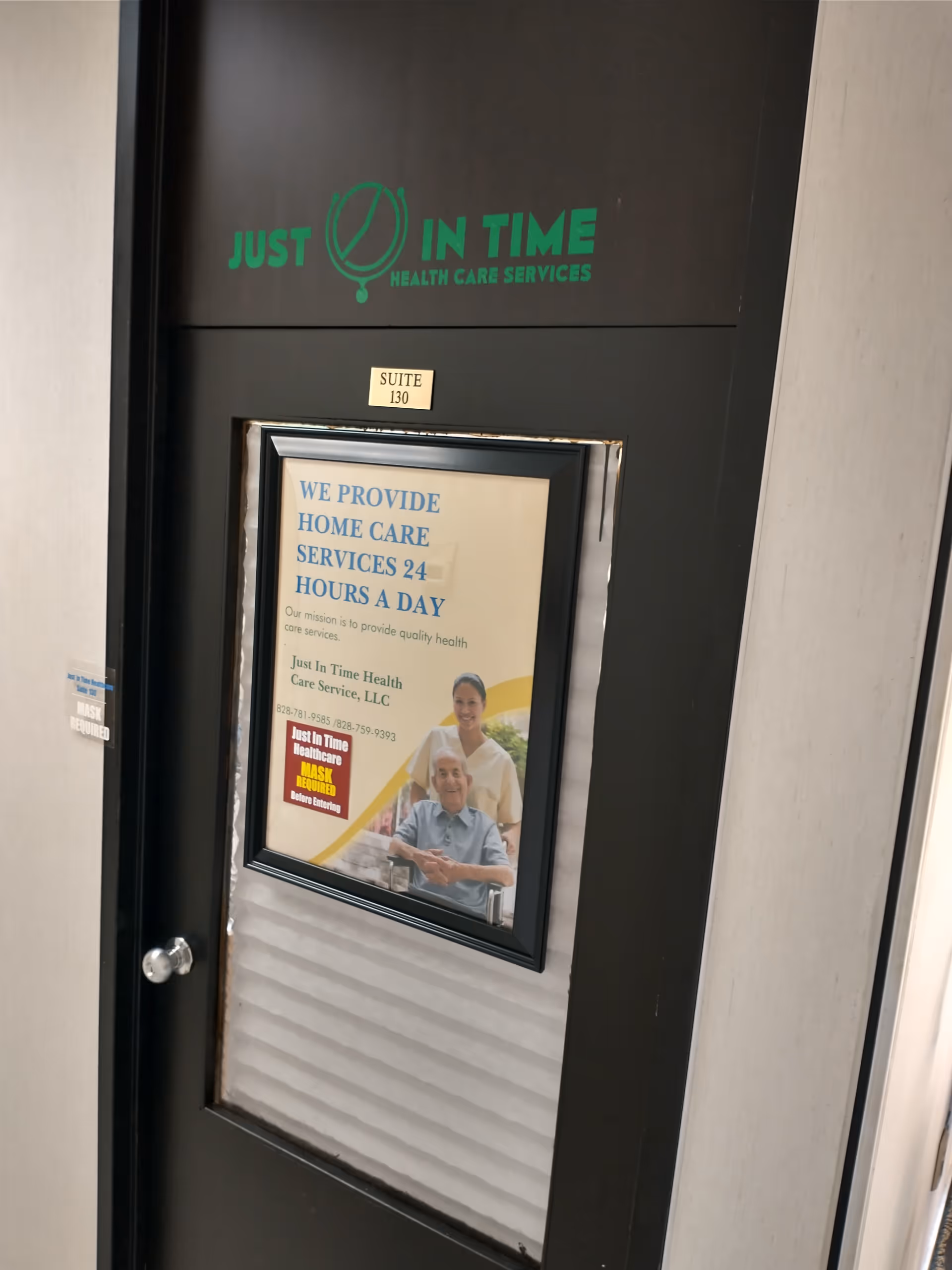 Interior door with Just in Time Health Care Services logo and a poster about 24-hour care.