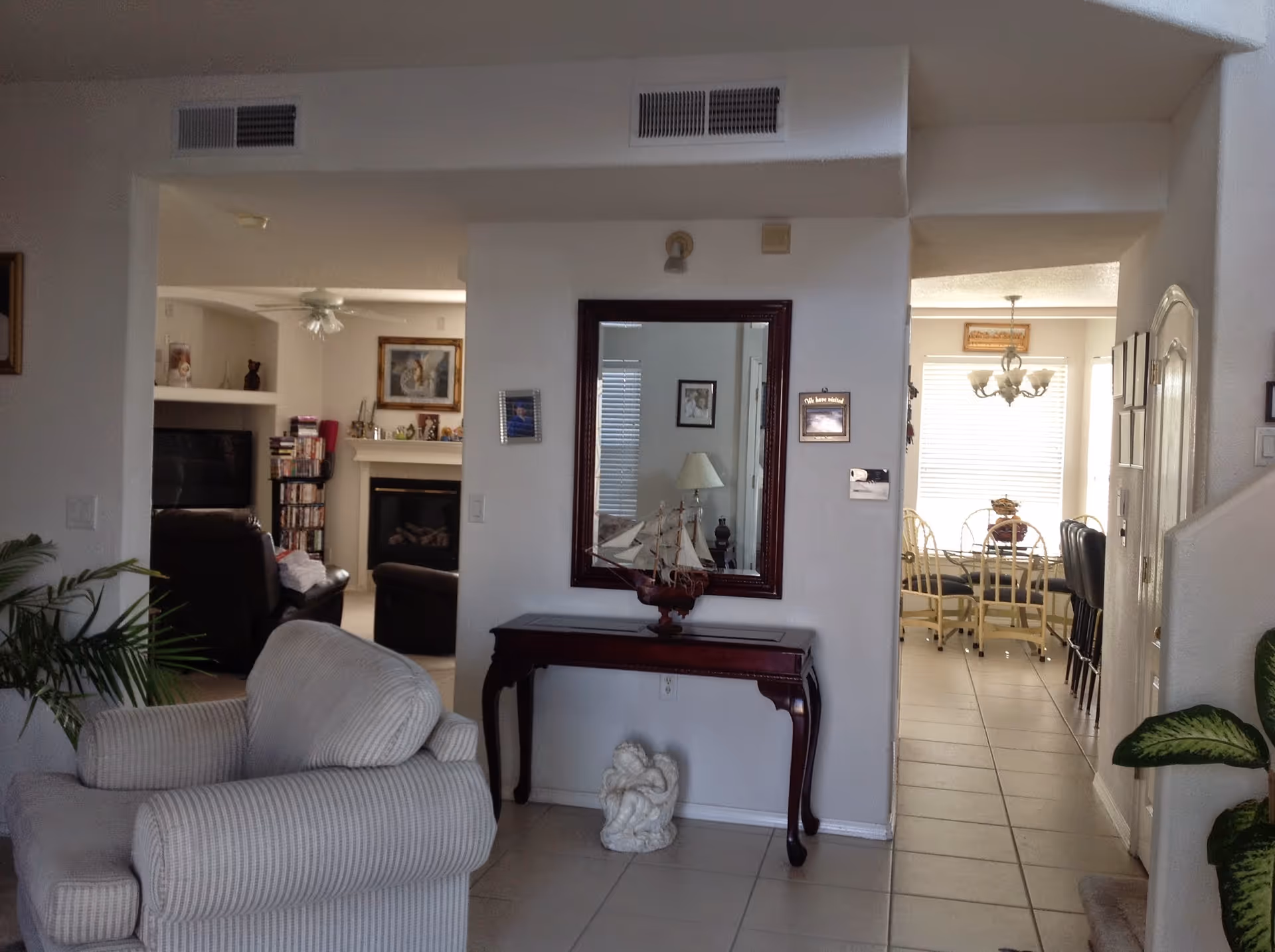 Interior common area of Angel's Heaven Adult Foster Home with sofa, mirror, and dining room.