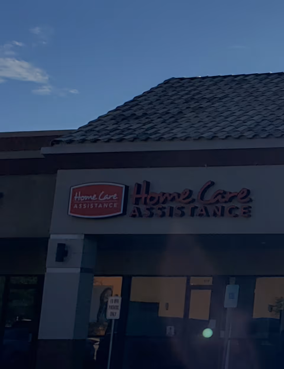 Exterior view of a senior care building with a 'Home Care Assistance' sign.