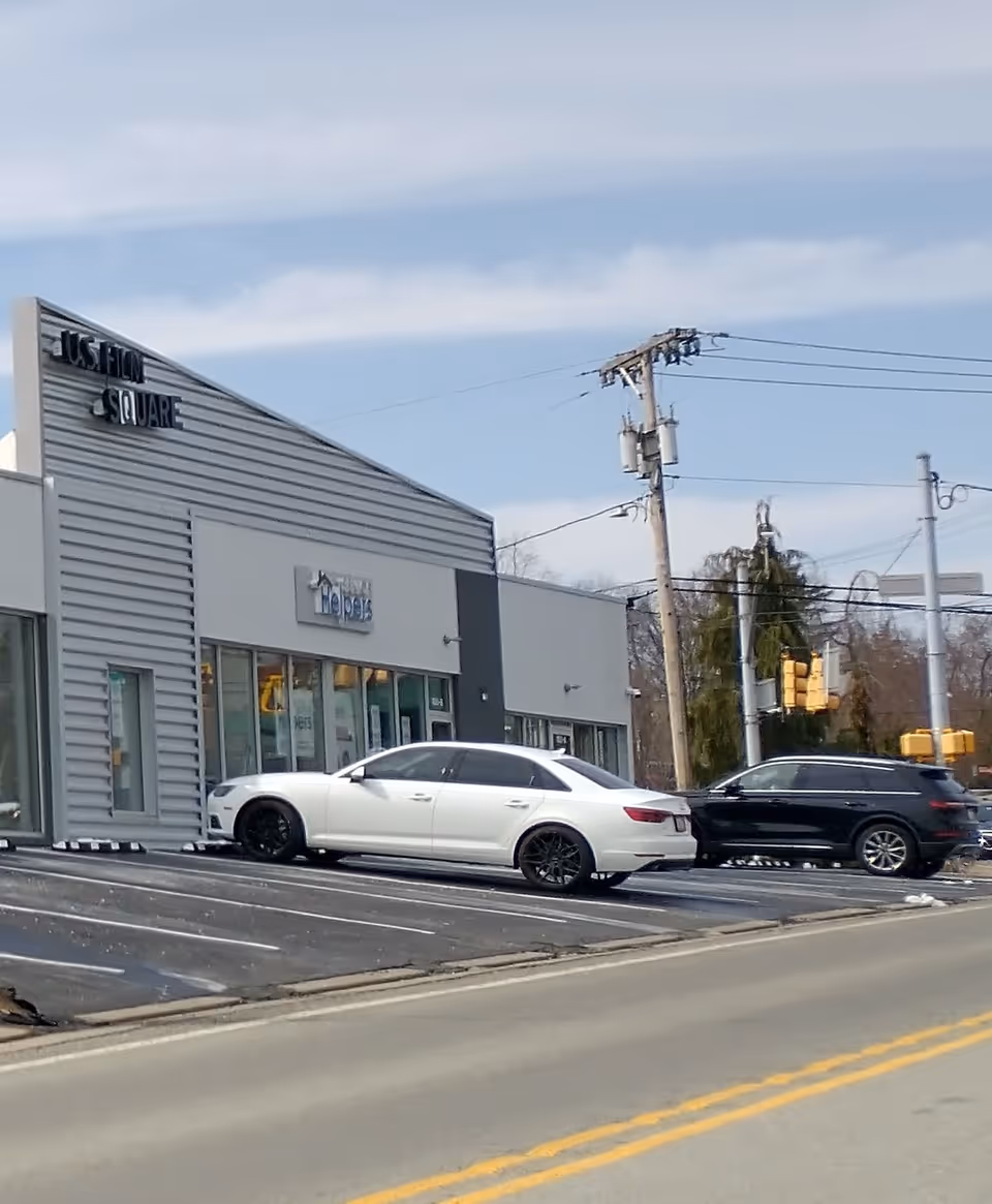 Exterior view of a Senior Helpers facility with two cars parked in front.