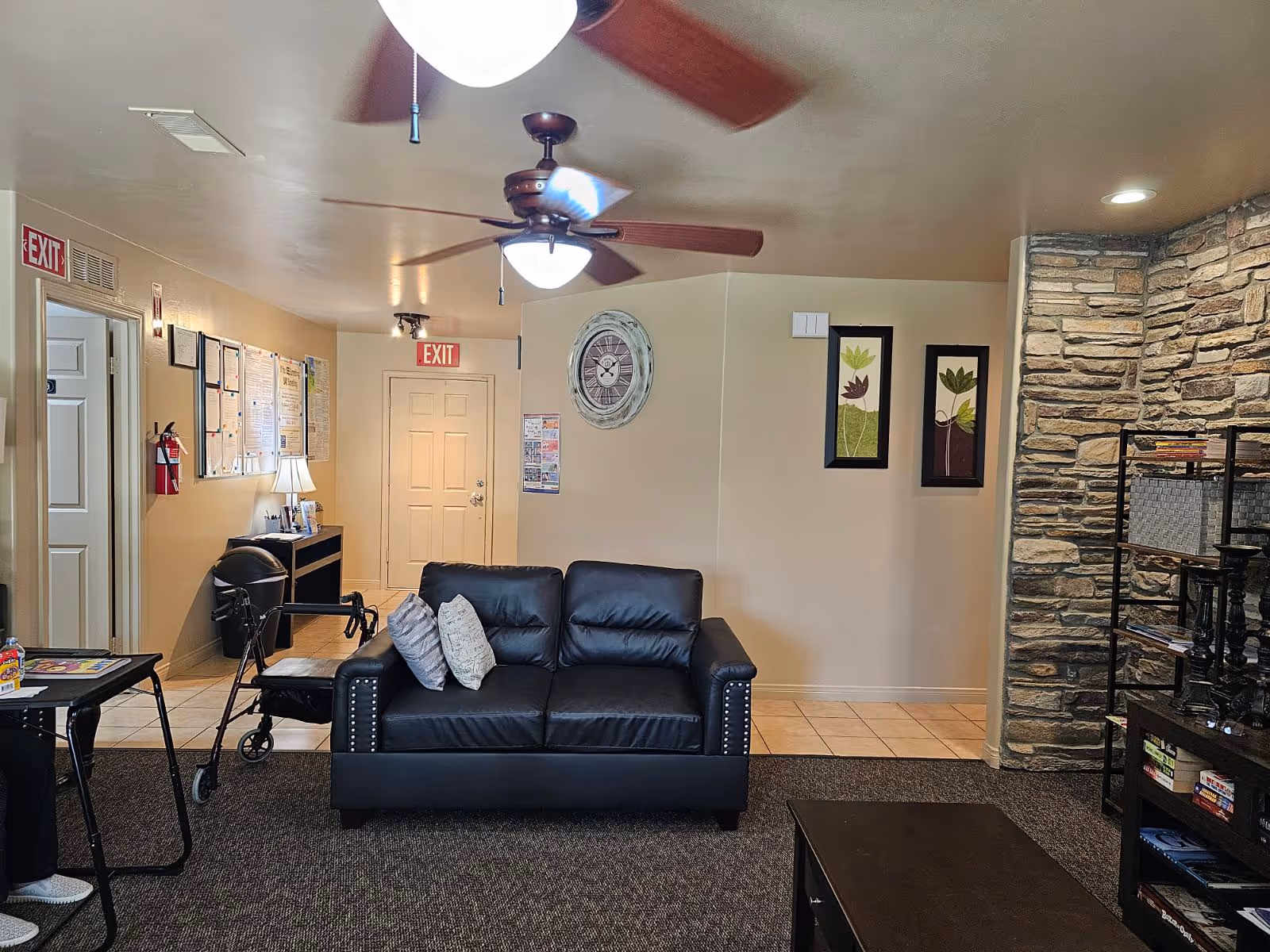 Cozy lounge area in a senior facility featuring a black leather sofa.