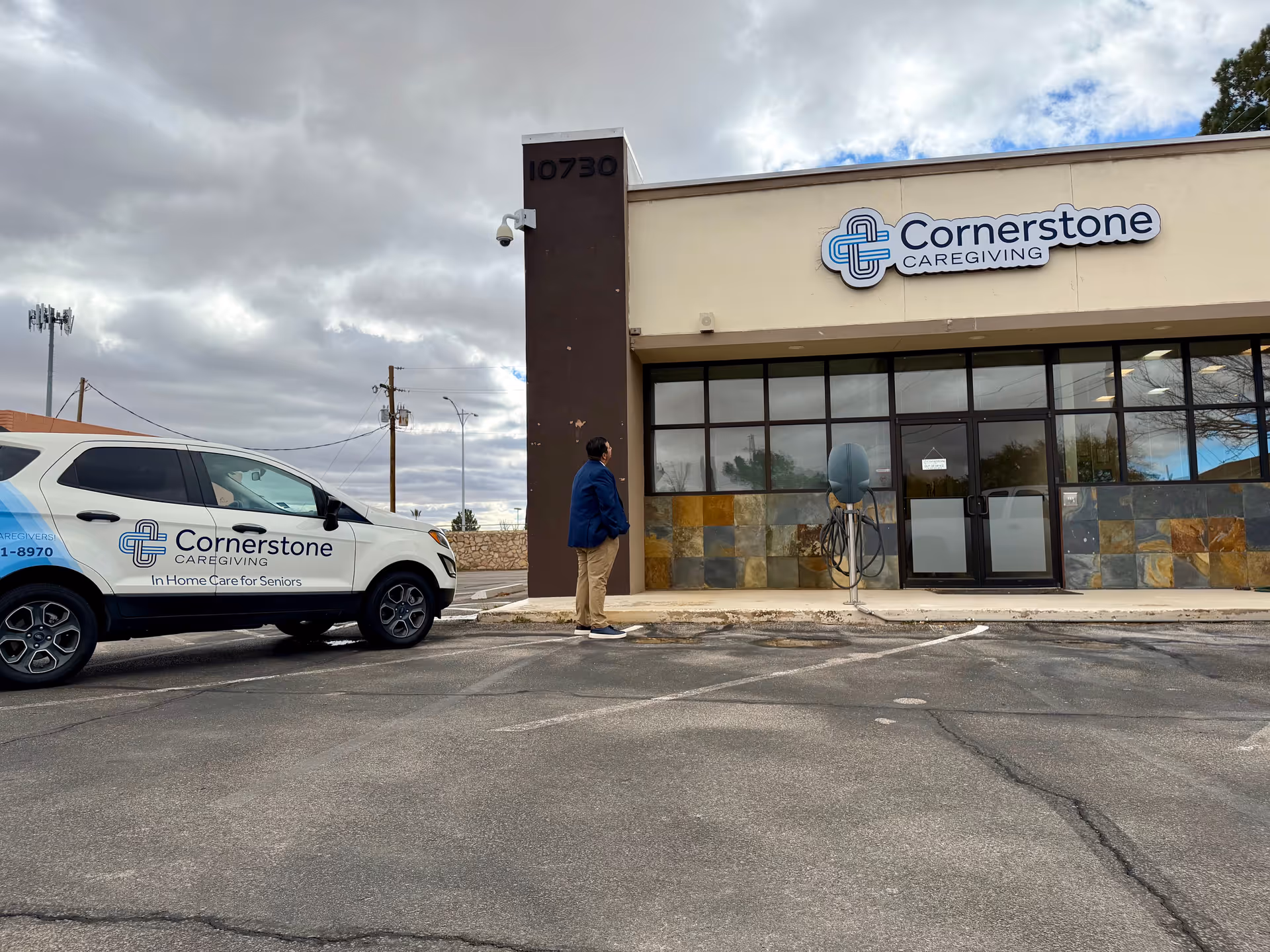 Front view of Cornerstone Caregiving building with a branded van outside.