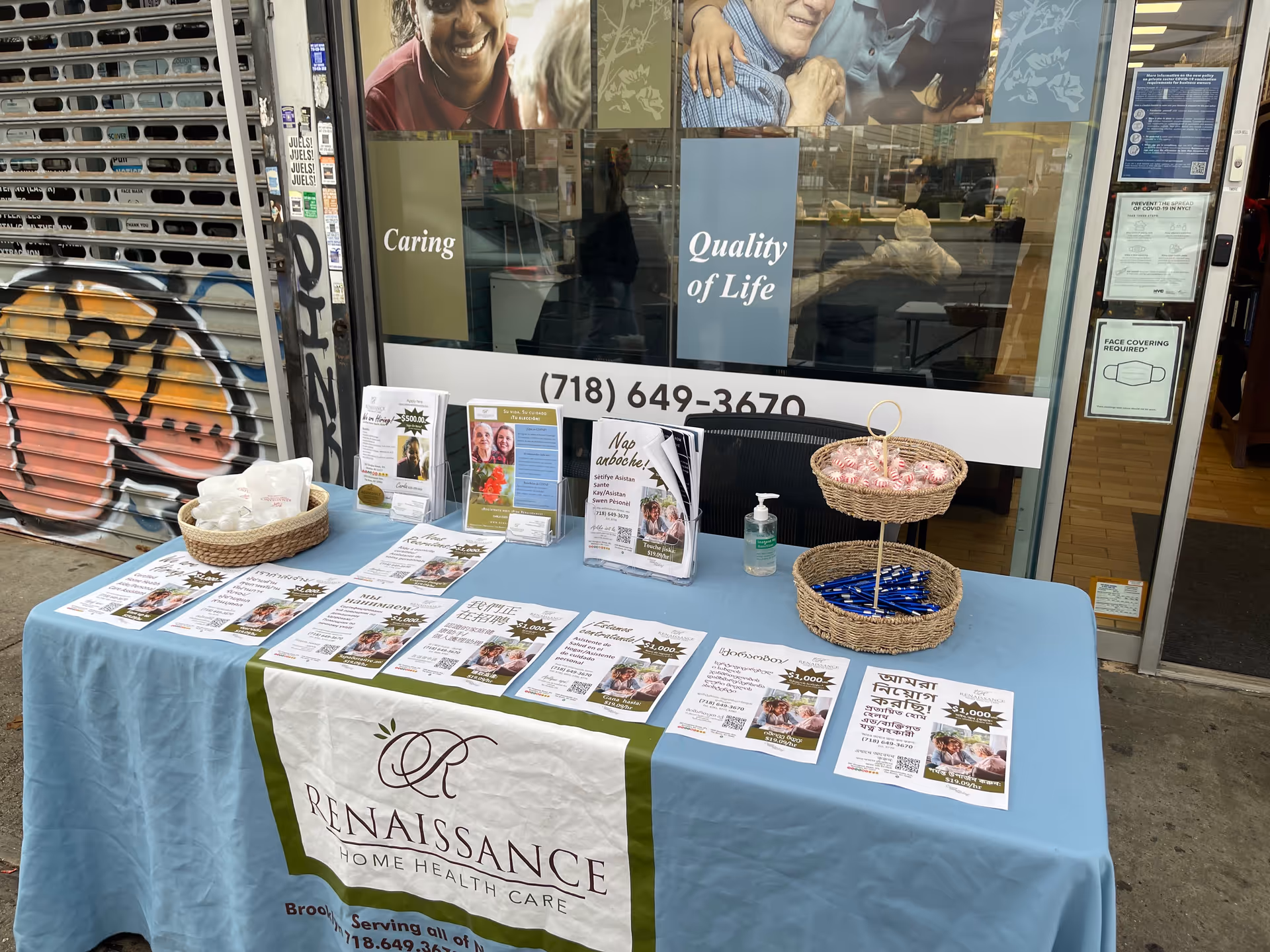Promotional table with brochures and baskets outside Renaissance Home Health Care storefront.