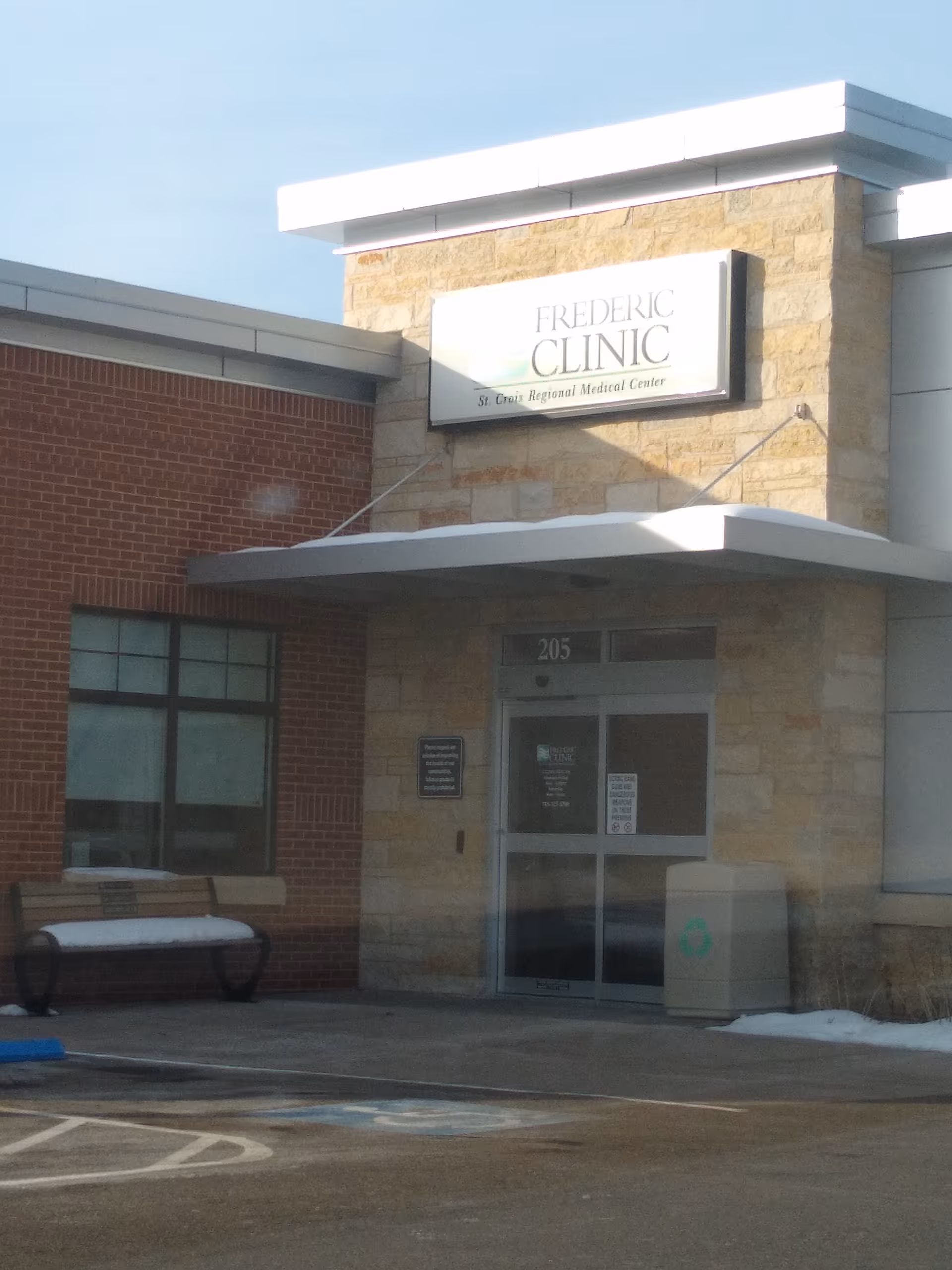 Front facade of FREDERIC CLINIC medical building with a stone entrance and glass doors.