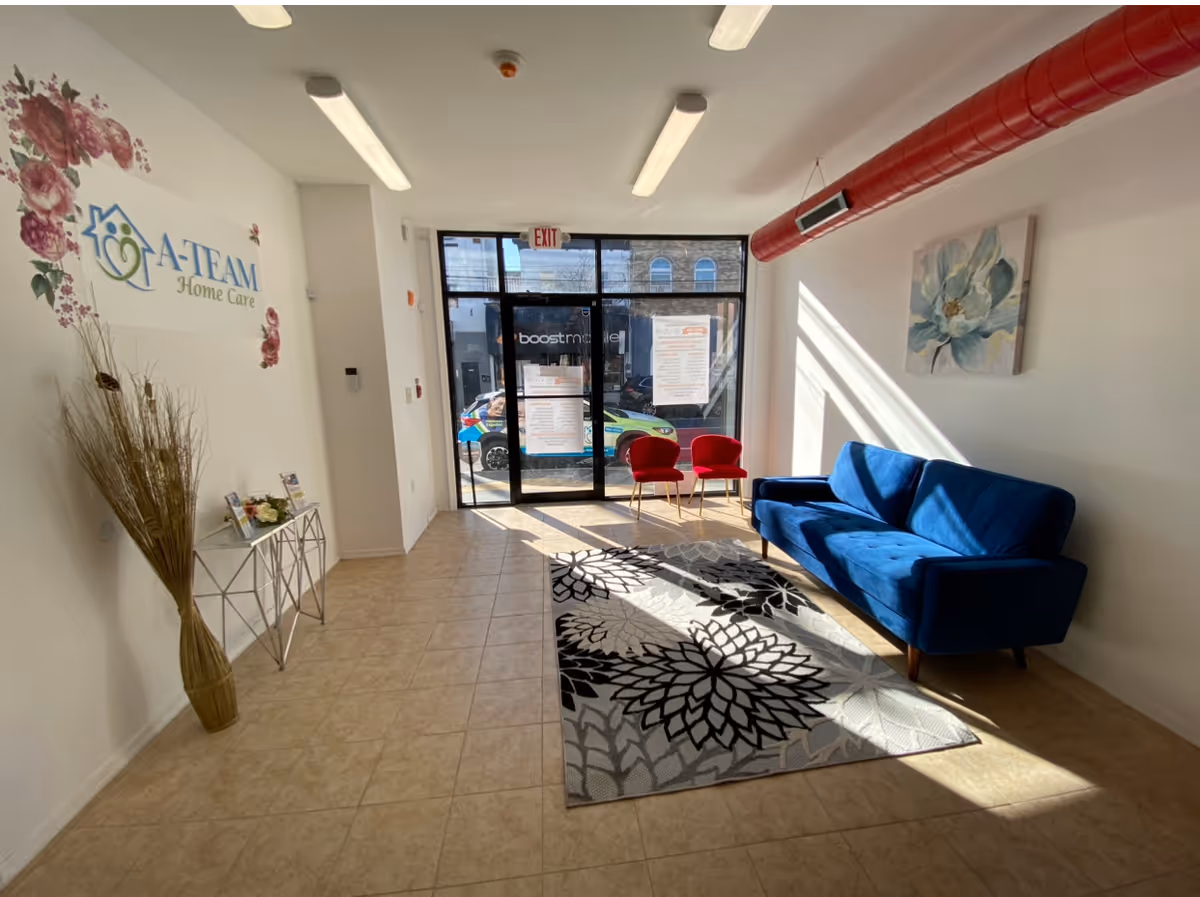 Lobby area of A-Team Home Care Philadelphia with blue sofa and glass entrance.