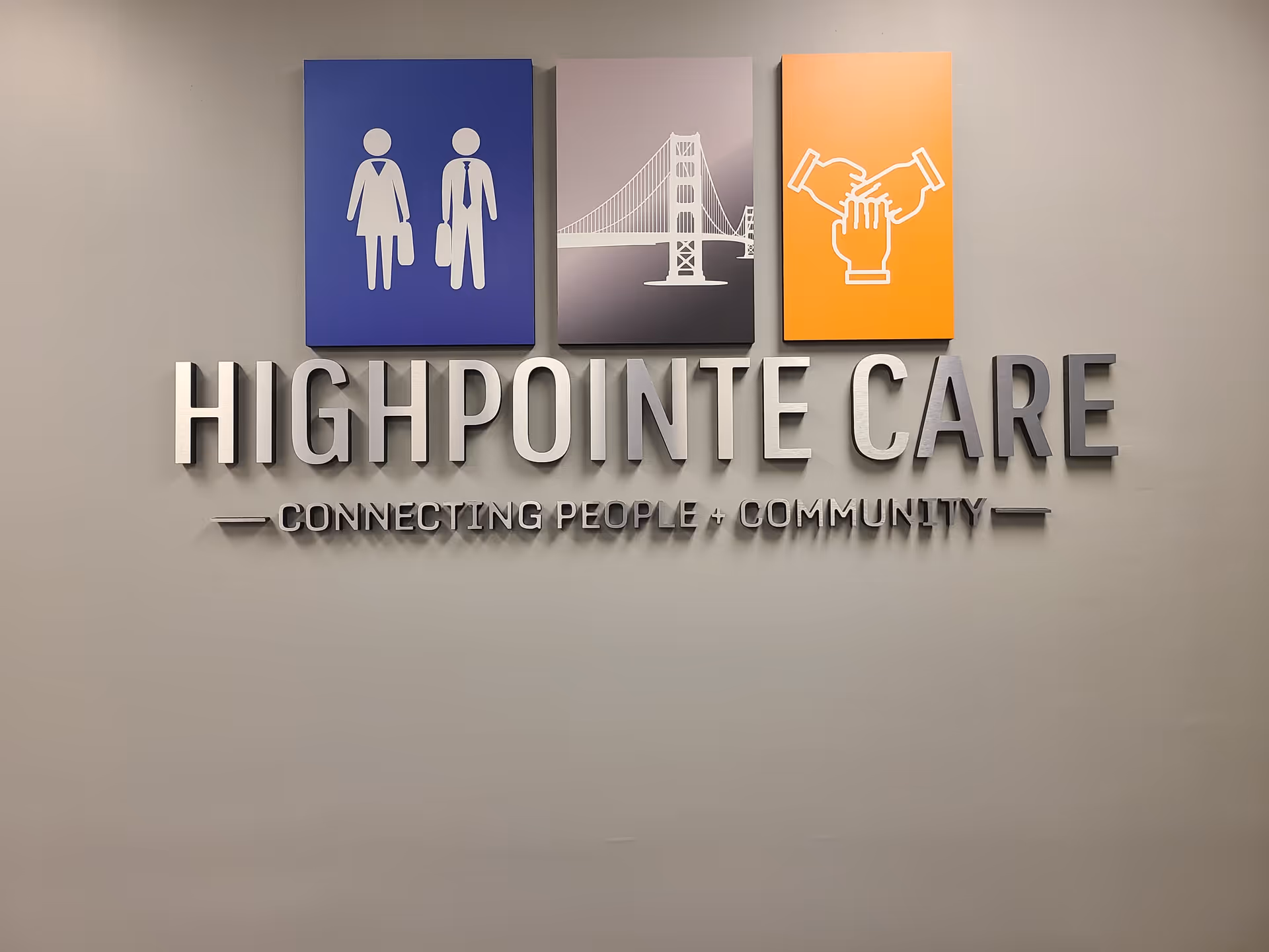 Interior wall sign reading HIGHPOINTE CARE with blue, gray, orange icons above.