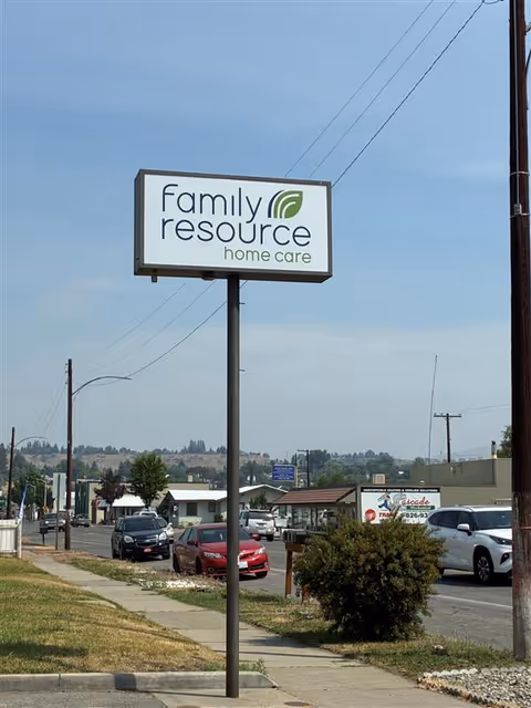 Street view with a tall sign reading Family Resource Home Care beside a sidewalk