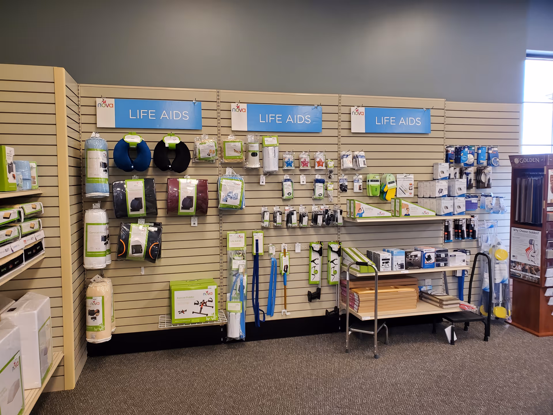 Interior display wall featuring life aids and medical supplies arranged on hooks and shelves.