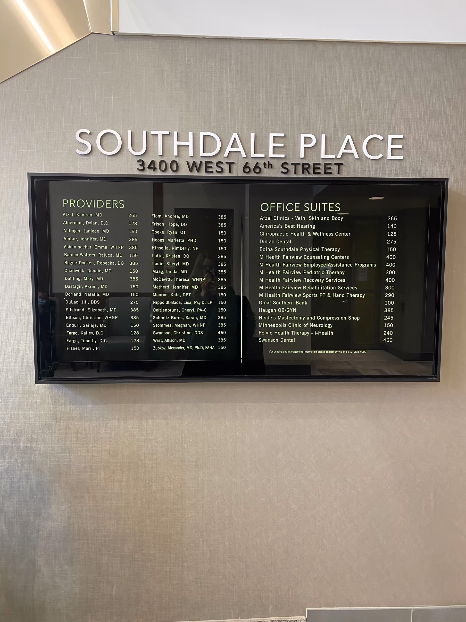 Interior wall with a Southdale Place directory board listing providers and offices.