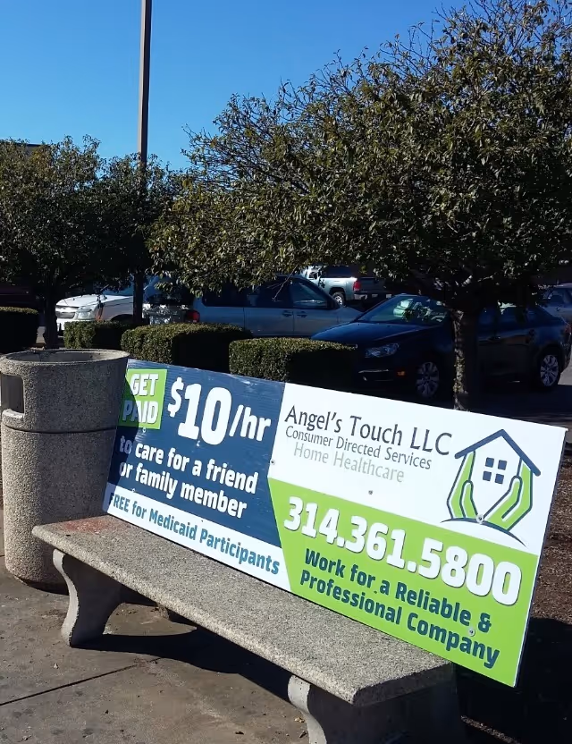 Outdoor bench displaying a large sign for Angel's Touch Home Healthcare.