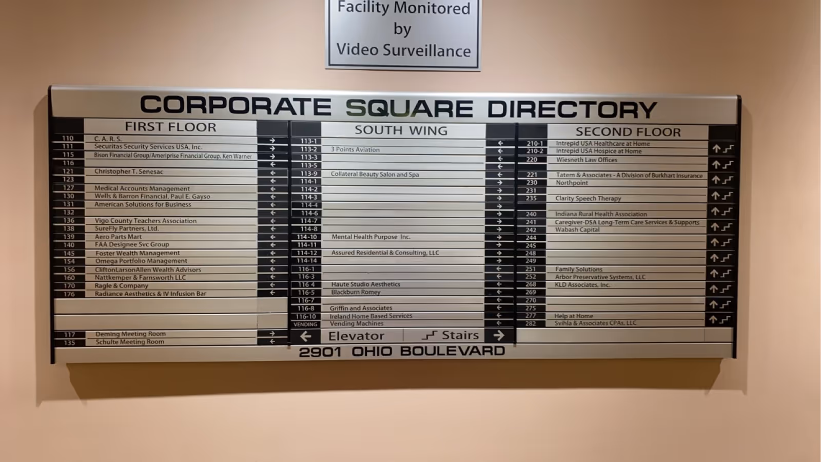 Interior hallway with a large Corporate Square Directory sign and a video surveillance notice.
