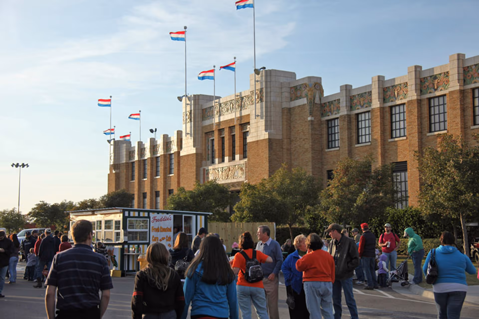 Exterior view of a brick building with a crowd gathered outside.