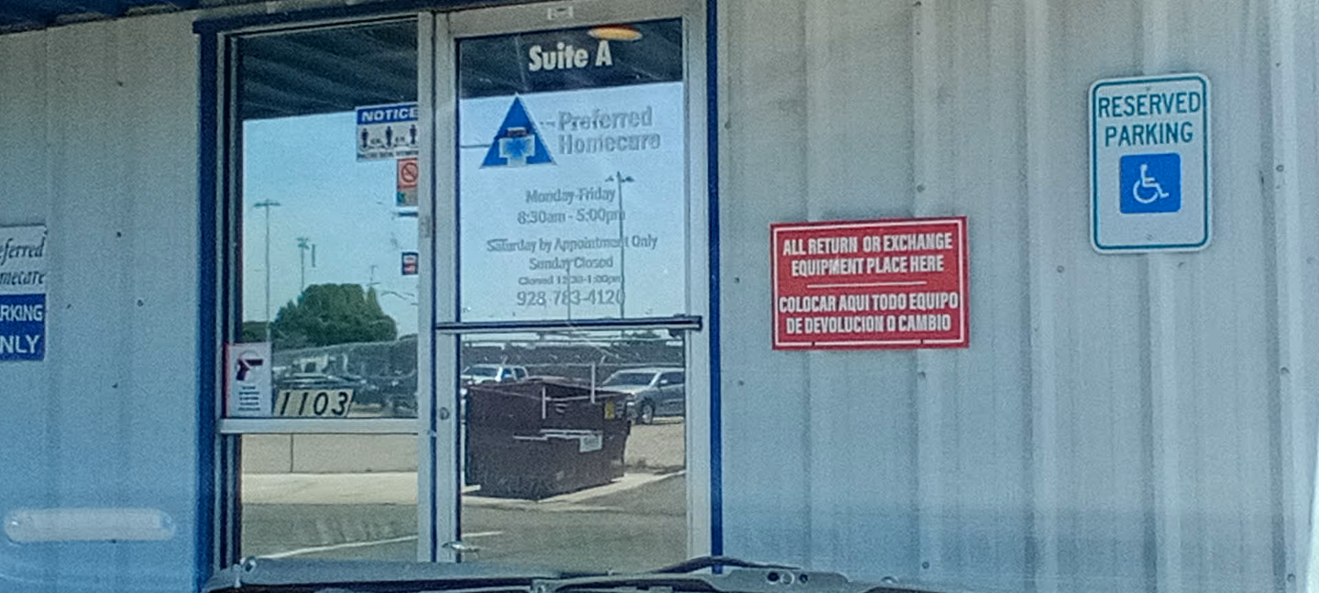 Front entrance of Preferred Homecare facility with signs and a reserved parking sign.