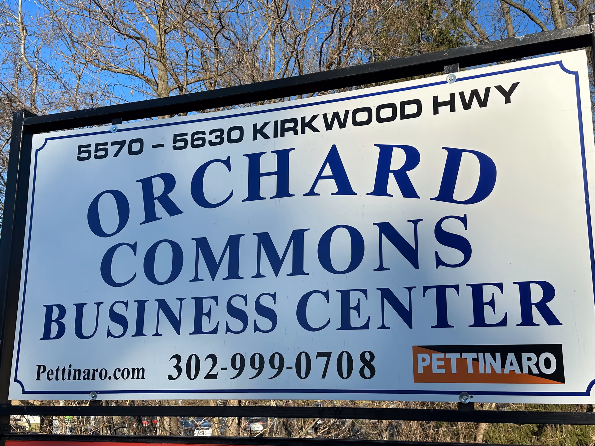 Large outdoor sign reading Orchard Commons Business Center on Kirkwood Hwy with Pettinaro logo.