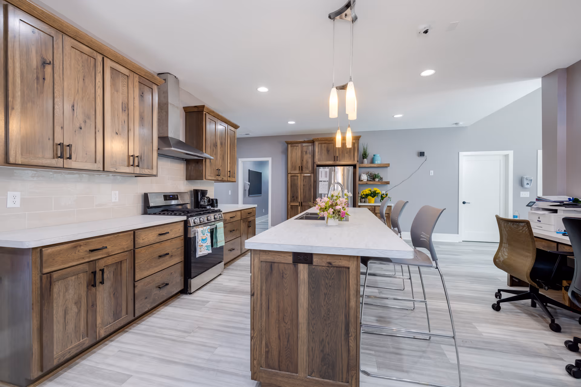 Modern kitchen with wooden cabinets, a central island, and stainless steel appliances.