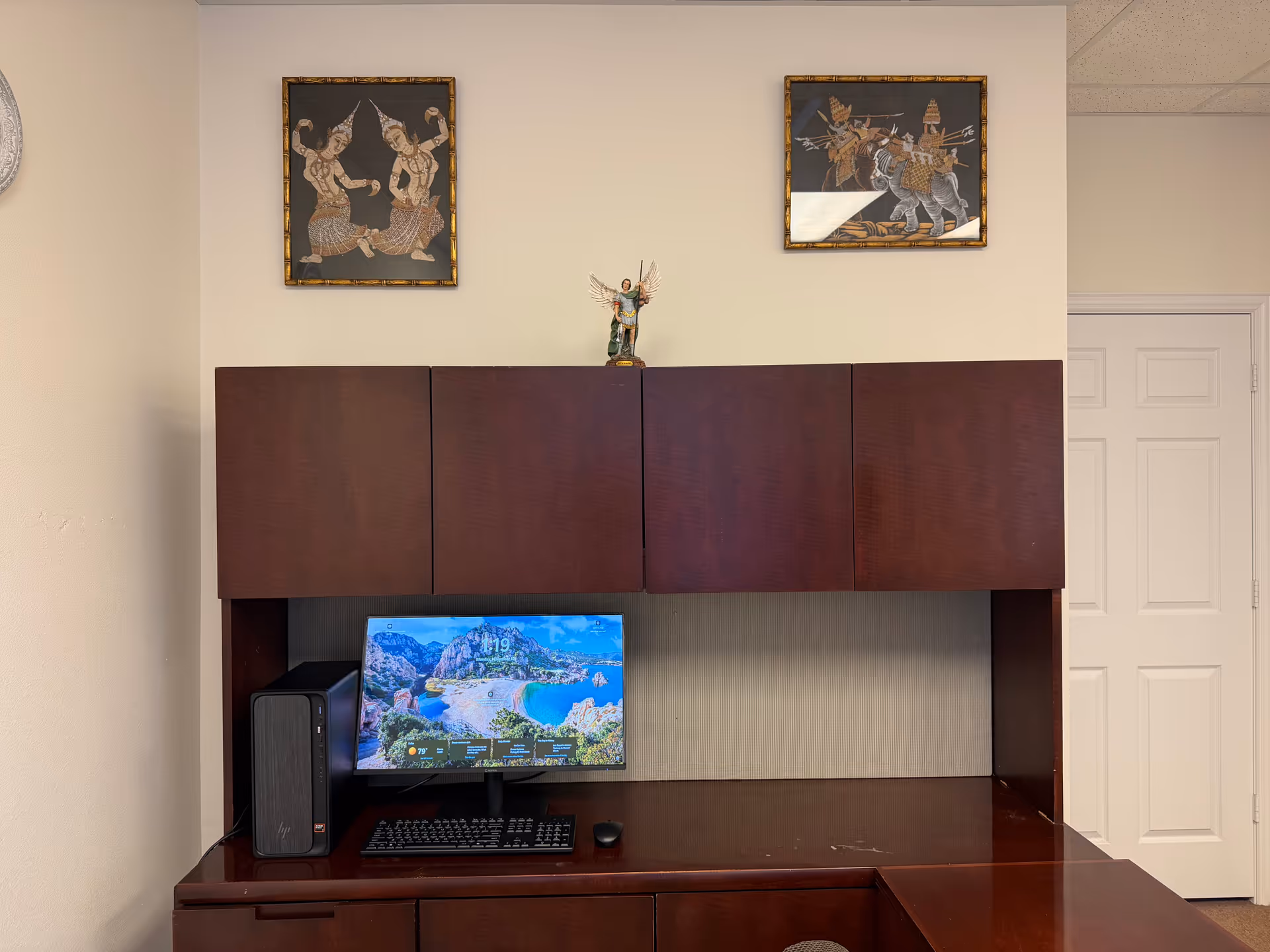 Wooden desk and computer setup in a senior living facility office.