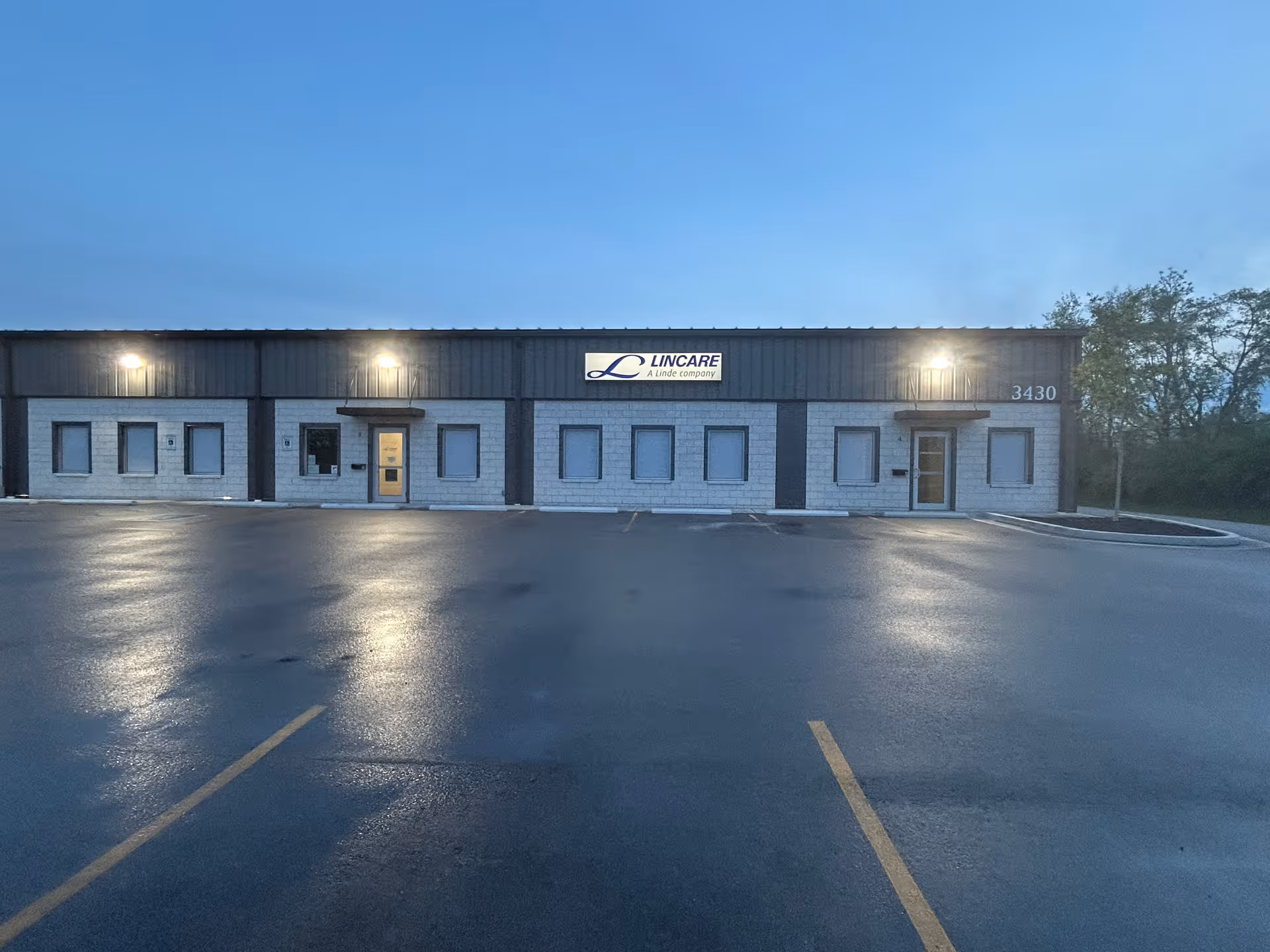 Front exterior of a LINCARE facility with a parking lot in the foreground.