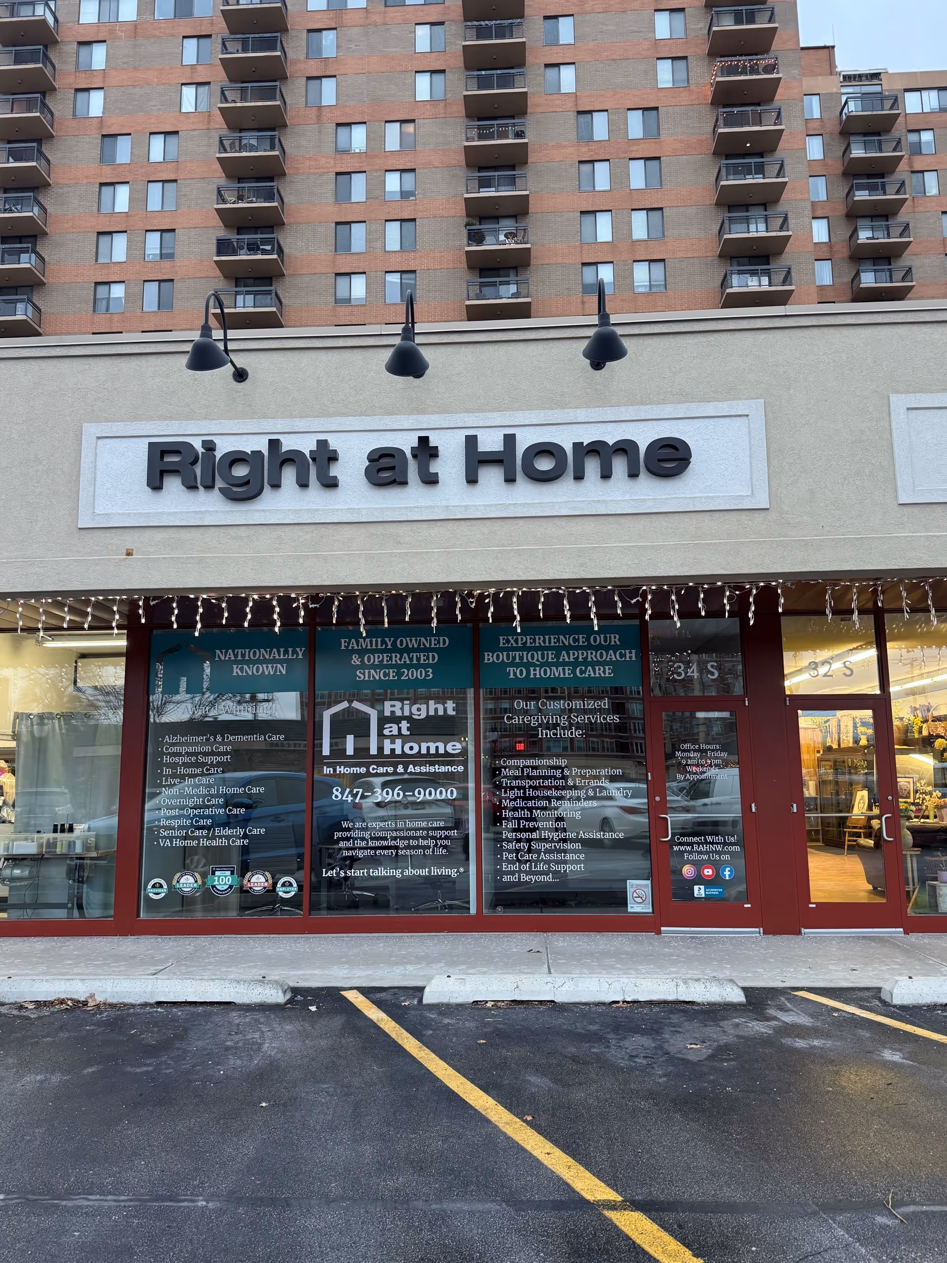 Multi-story building with a Right at Home storefront and large glass windows.