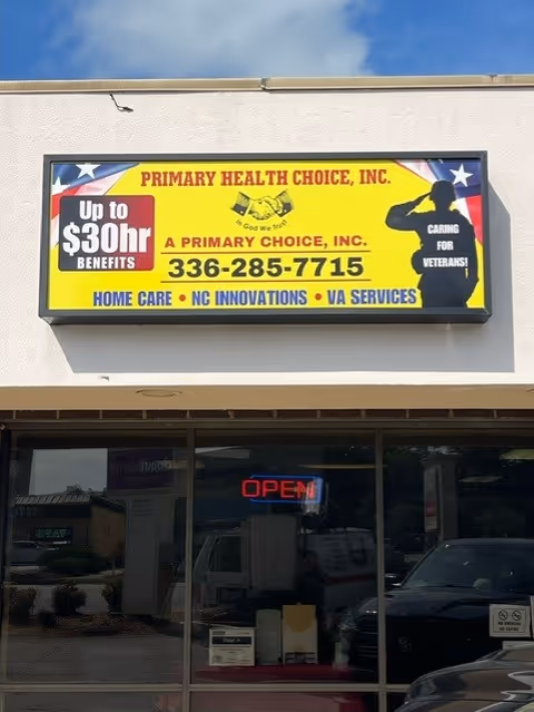 Exterior storefront showing a bright yellow sign for Primary Health Choice on a beige building.