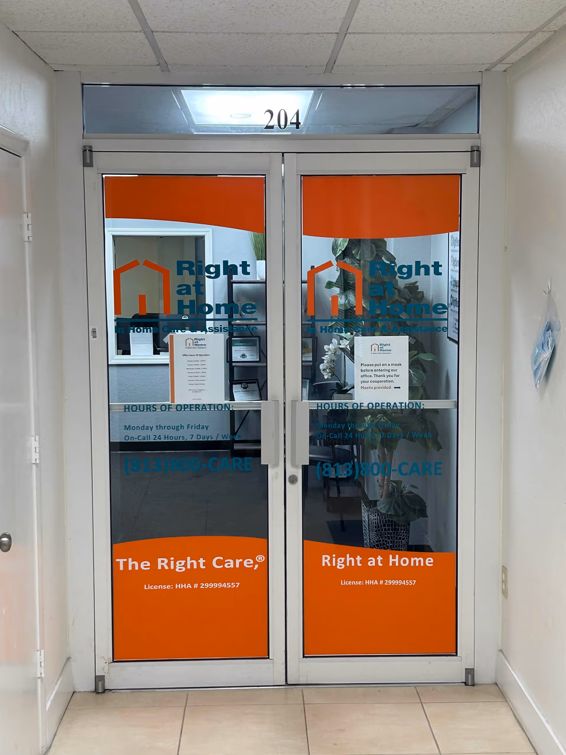 Double glass doors with Right at Home signage in a hallway.
