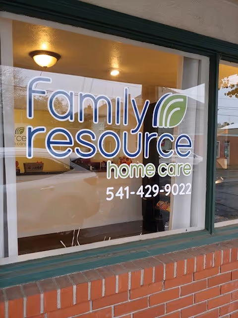 Storefront window with 'Family Resource Home Care' signage and brick exterior.