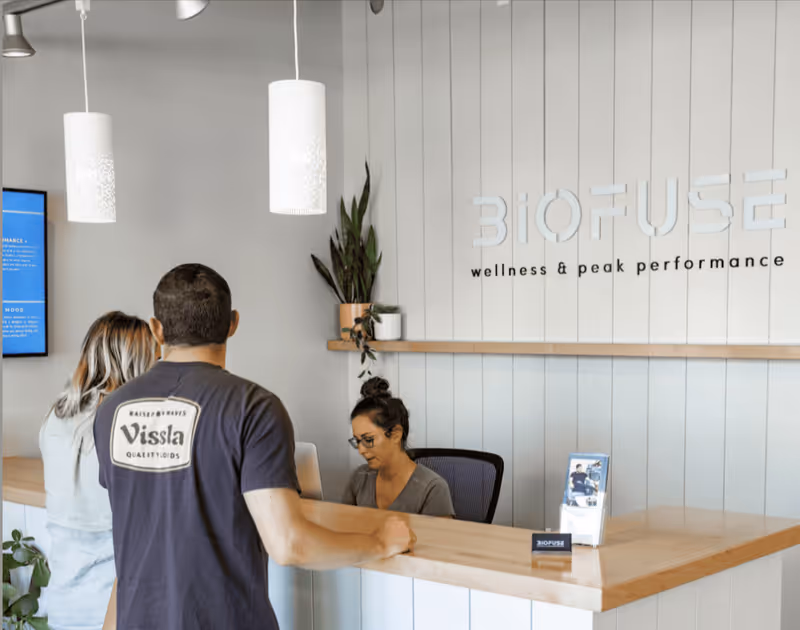 Reception area of Biofuse wellness with staff assisting clients at a counter.