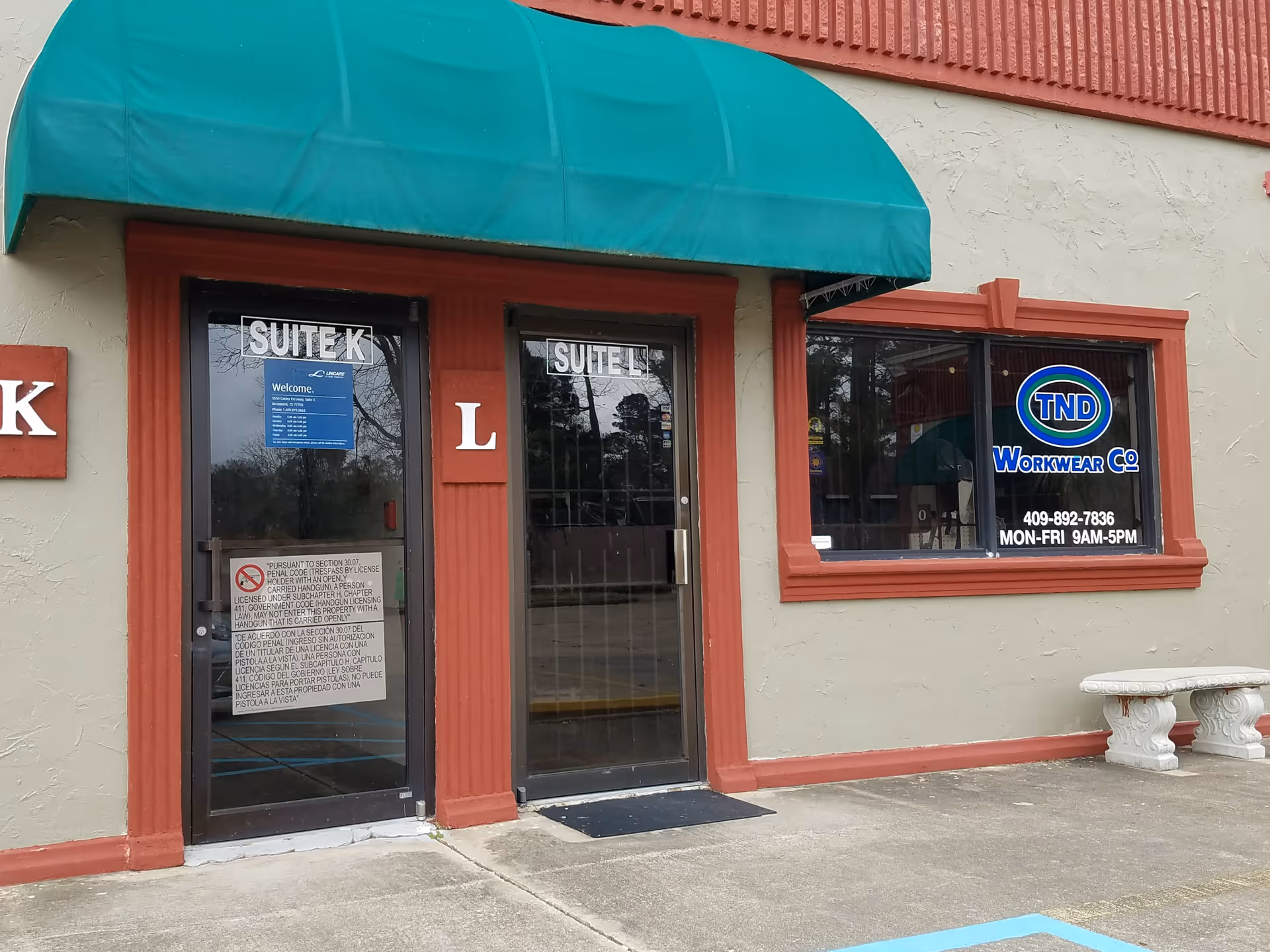 Exterior view of a LINCARE storefront with glass doors, teal awning, and bench.
