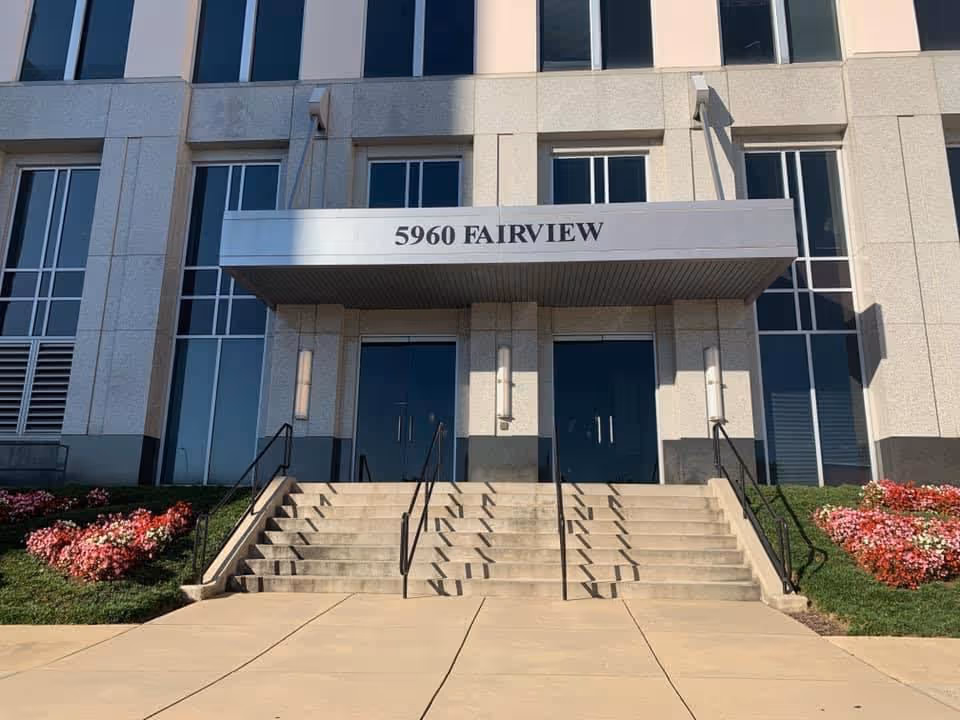 Modern building entrance labeled 5960 Fairview with stairs and landscaping.