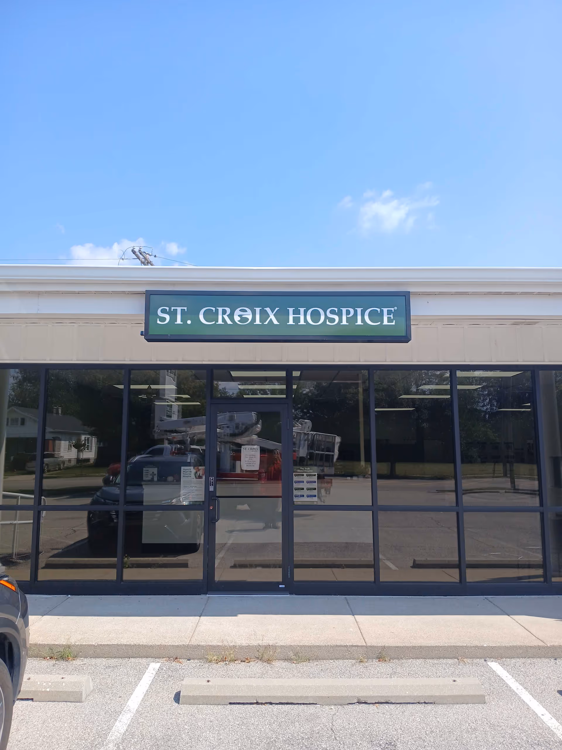 Front view of St. Croix Hospice storefront with glass doors and sign.
