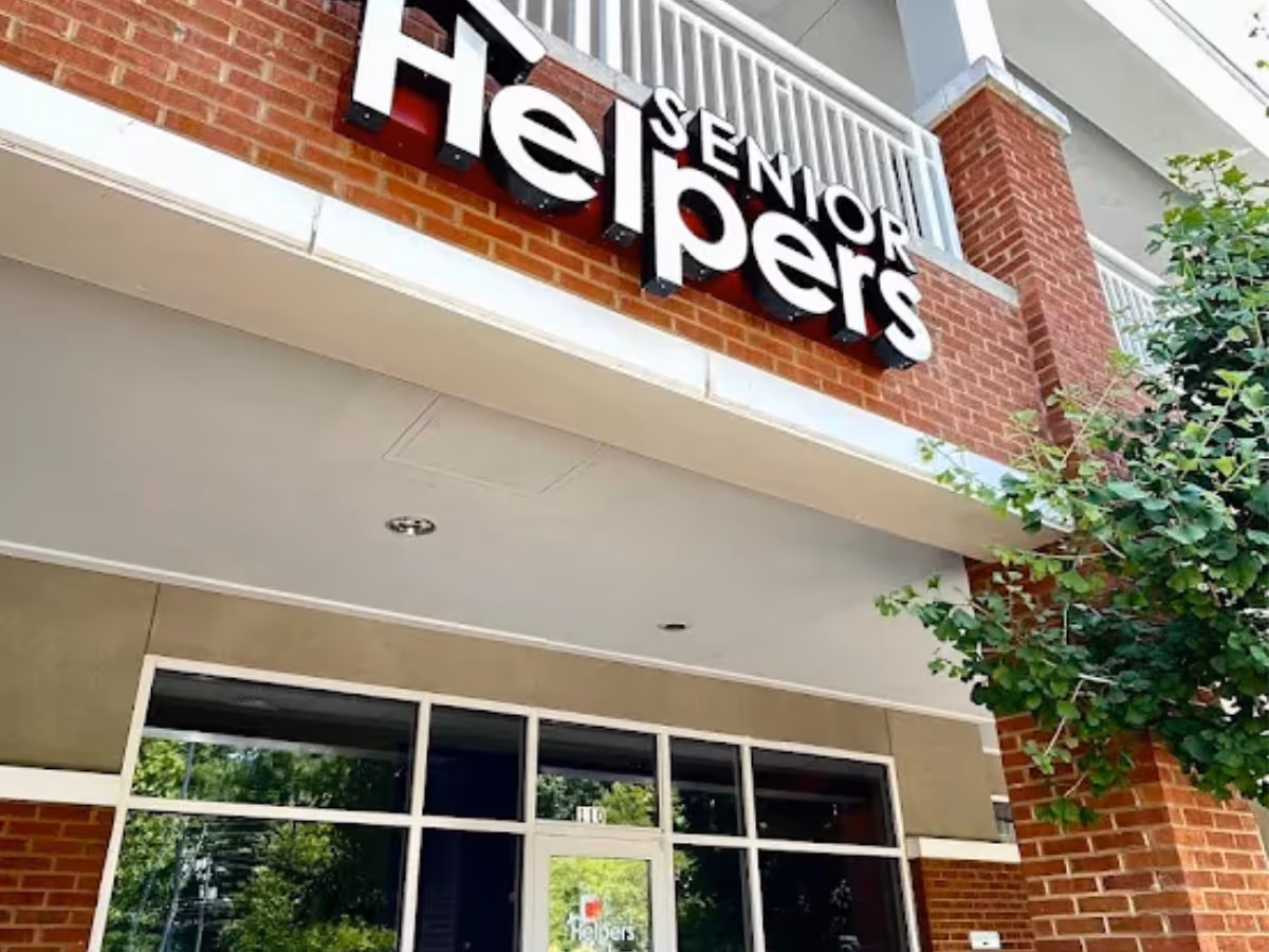Exterior view of a Senior Helpers facility with brick facade and glass entrance